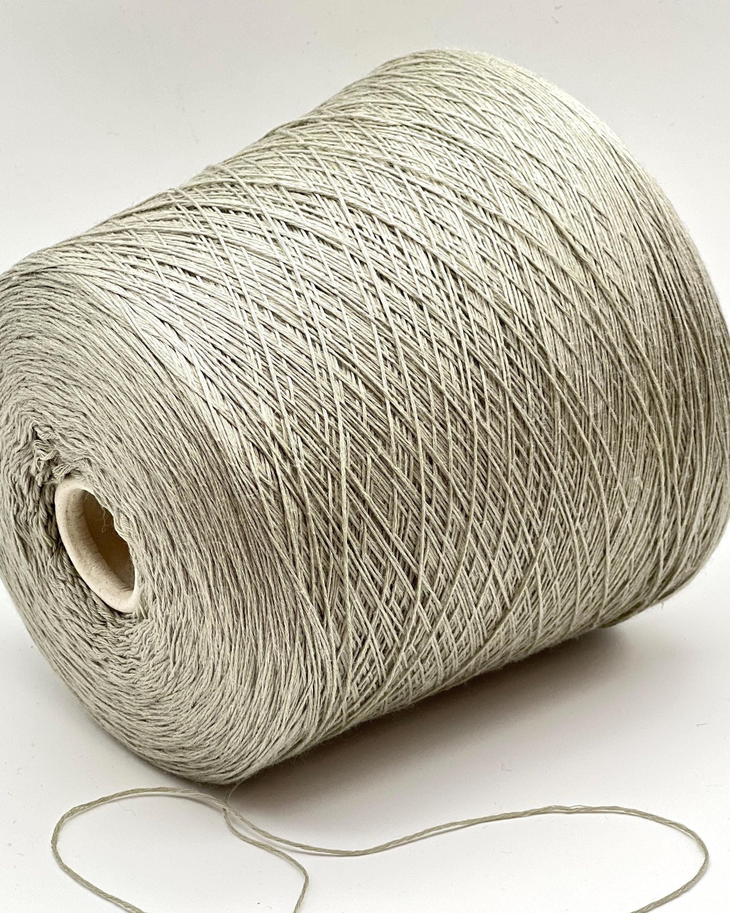 Roll of beige yarn on a white background