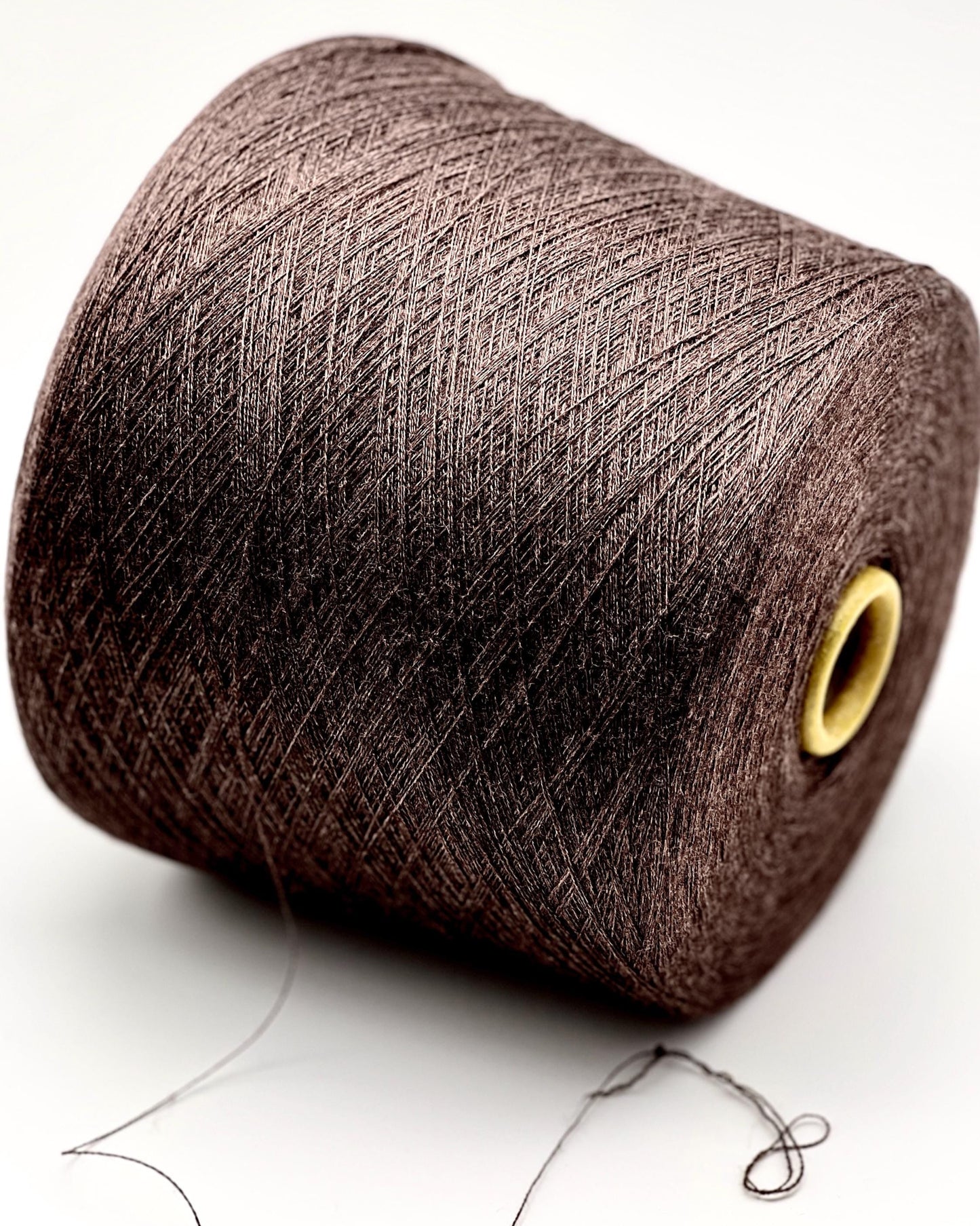 Brown spool of yarn on a white background