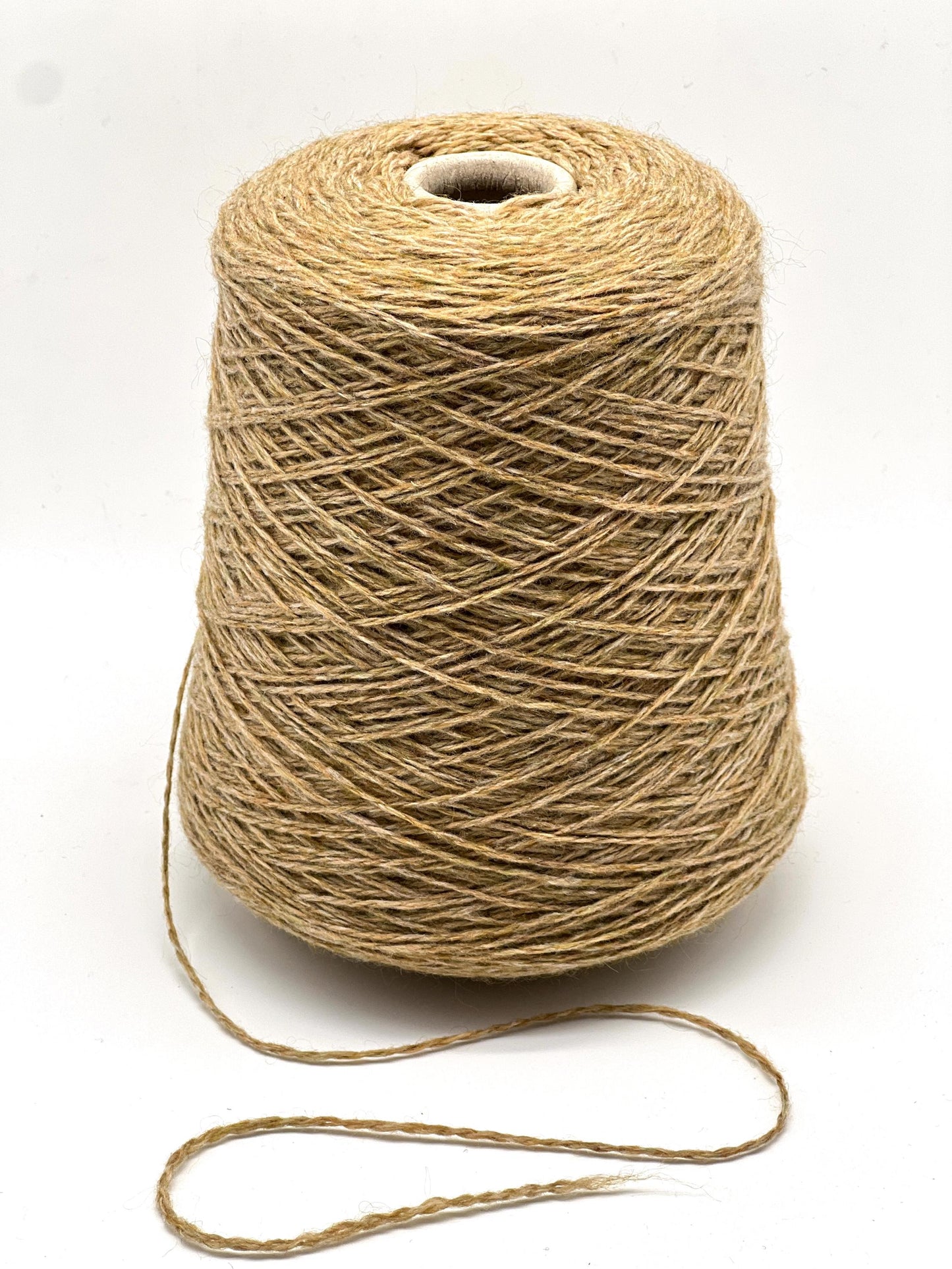 Spool of brown thread on a white background