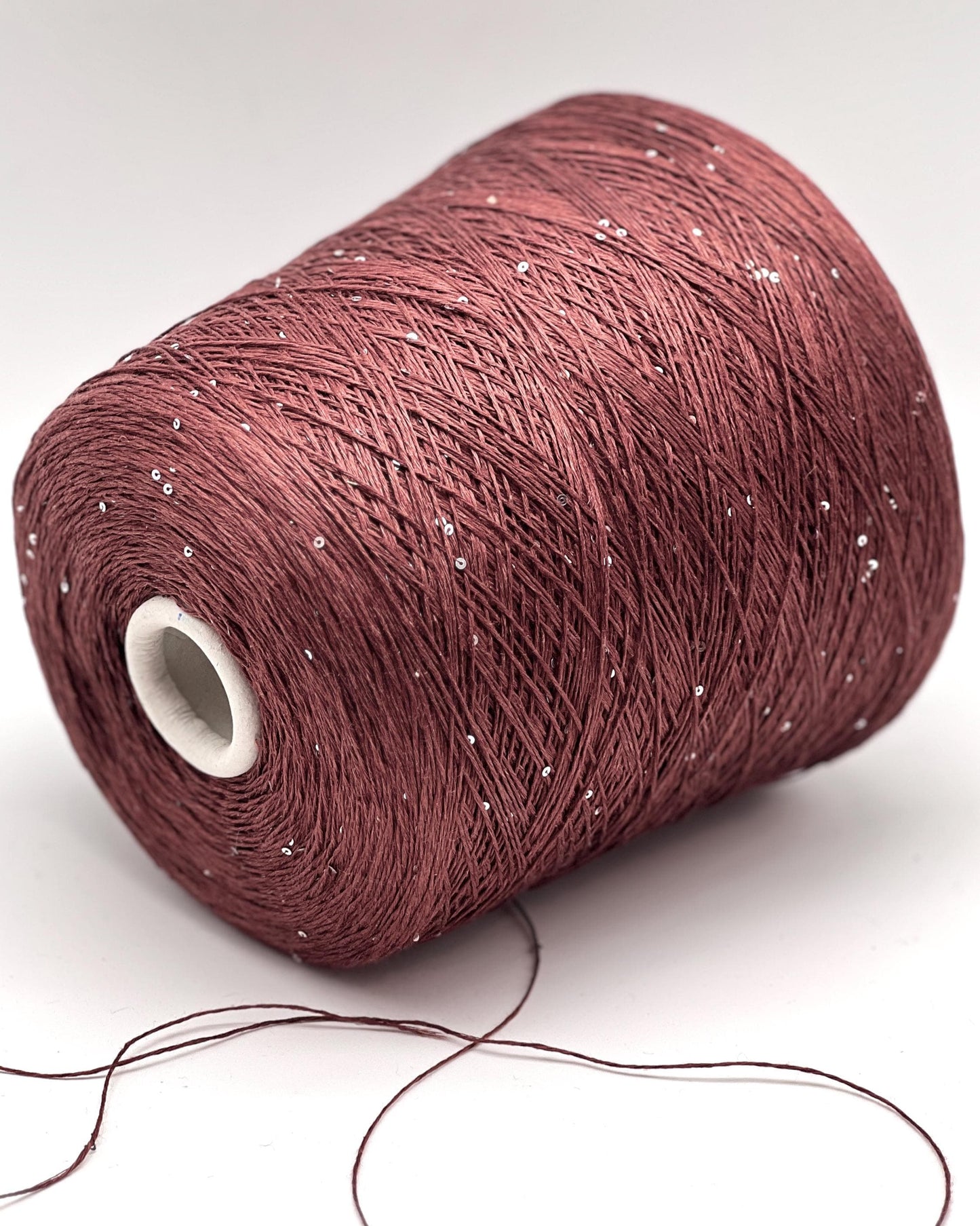 SAINT TROPEZ luxury yarn by RiGo, Italy – fingering weight blend of 80% linen, 15% silk, and 5% silver paillettes. Light, breathable, with a luminous sparkle. Ideal for elegant warm-weather knits. Brick color.