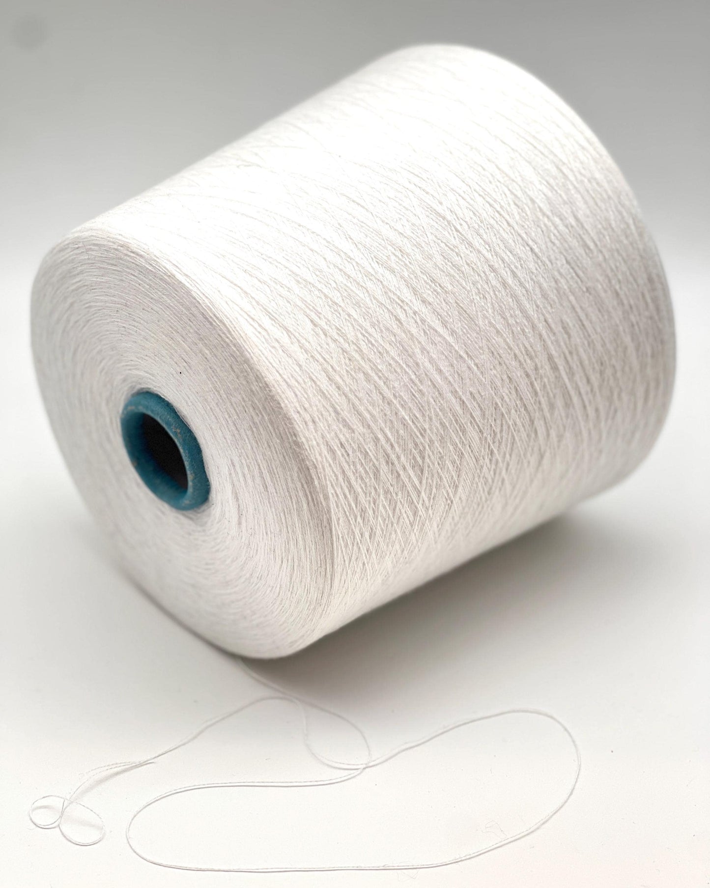 White spool of yarn on a white background