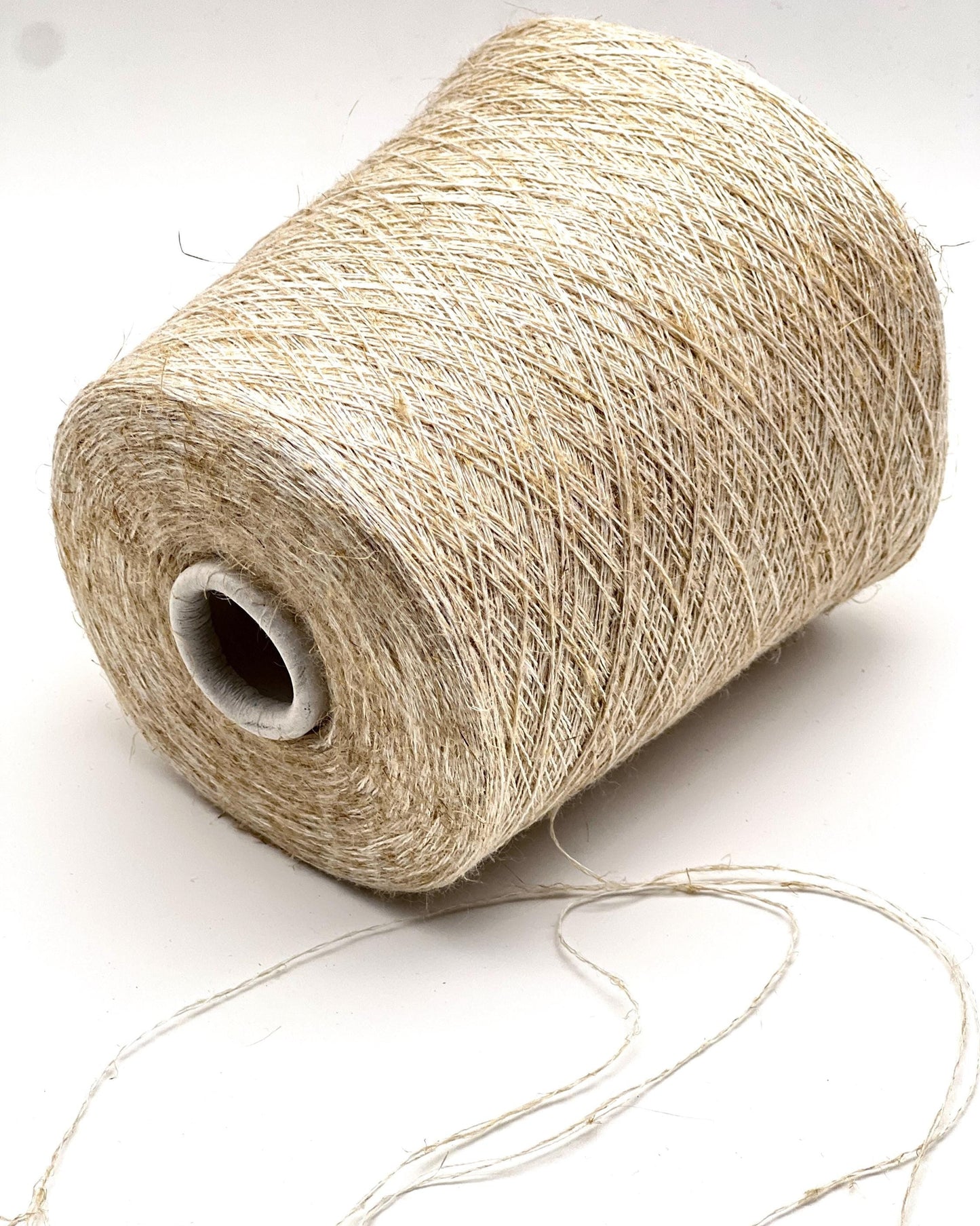 Spool of beige thread on a white background