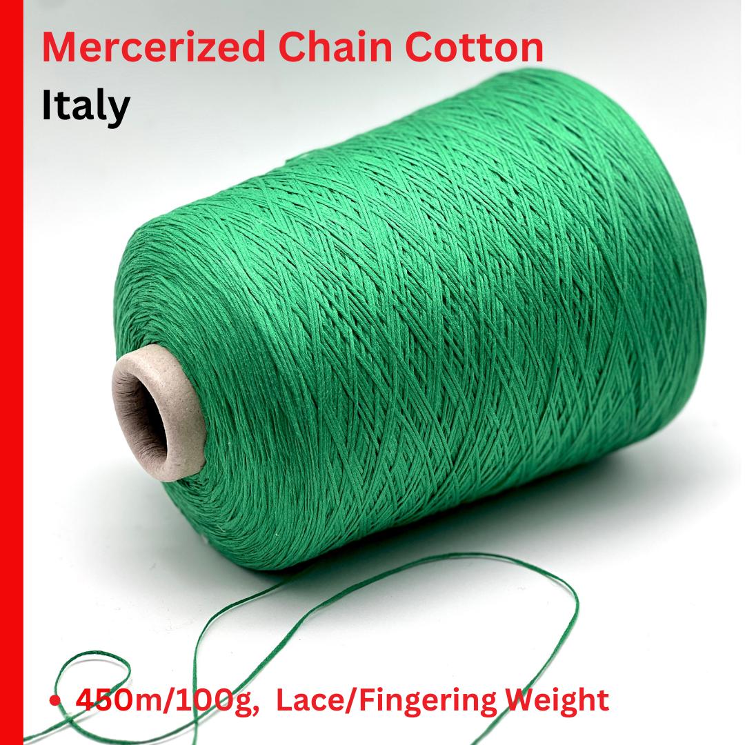 Green spool of Mercerized Chain Cotton from Italy on a white background