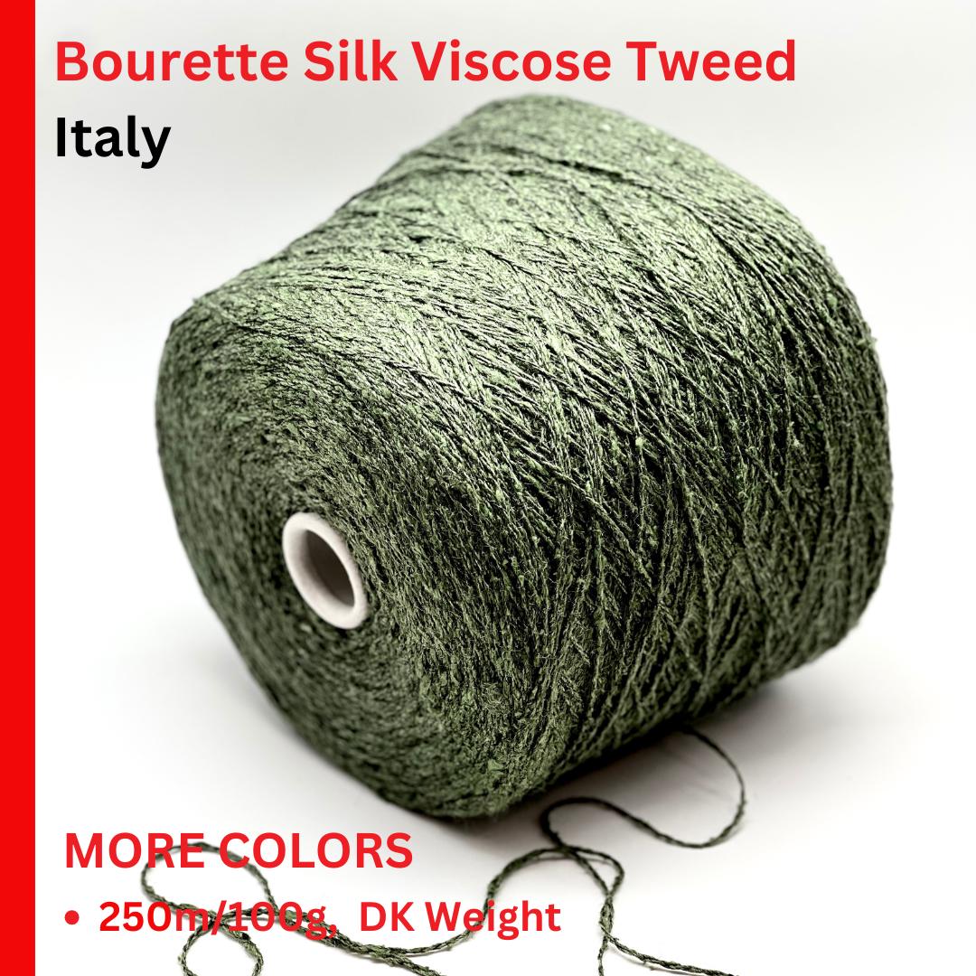 Green skein of Bourette Silk Viscose Tweed from Italy on a white background with text about color availability and weight.