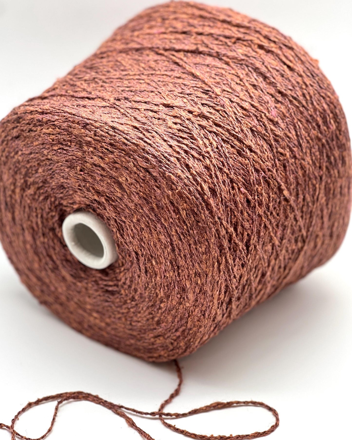 Brown yarn roll on a white background