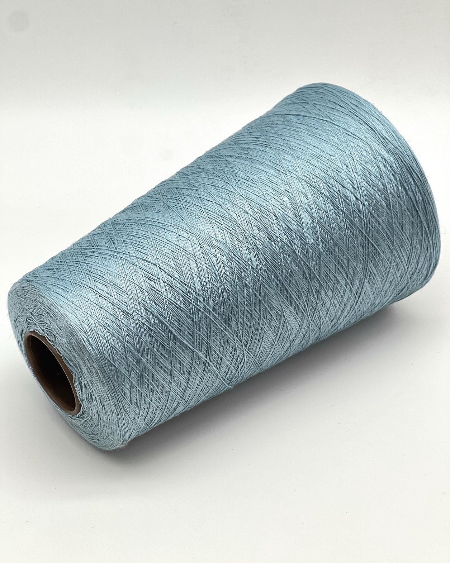 Roll of light blue yarn on a white background