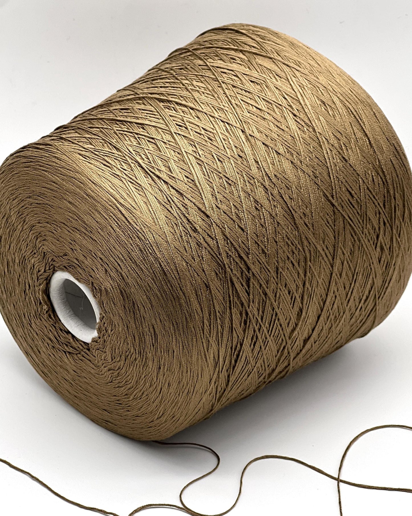 Large spool of brown thread on a white background