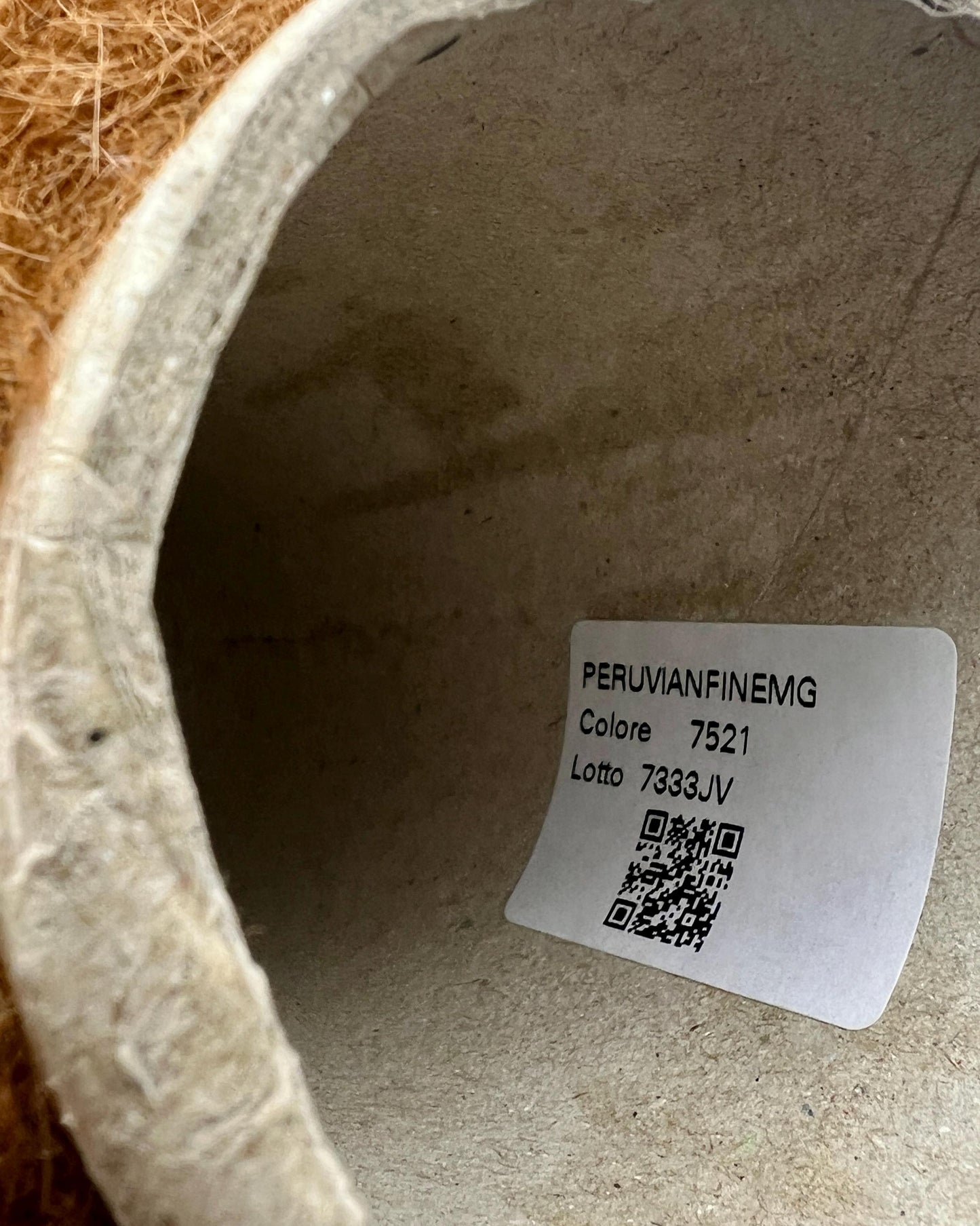 Label inside a concrete-like container with text and QR code