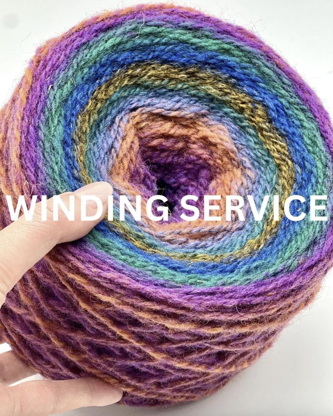Multicolored yarn ball with a hand holding it, labeled 'Winding Service' on a white background.
