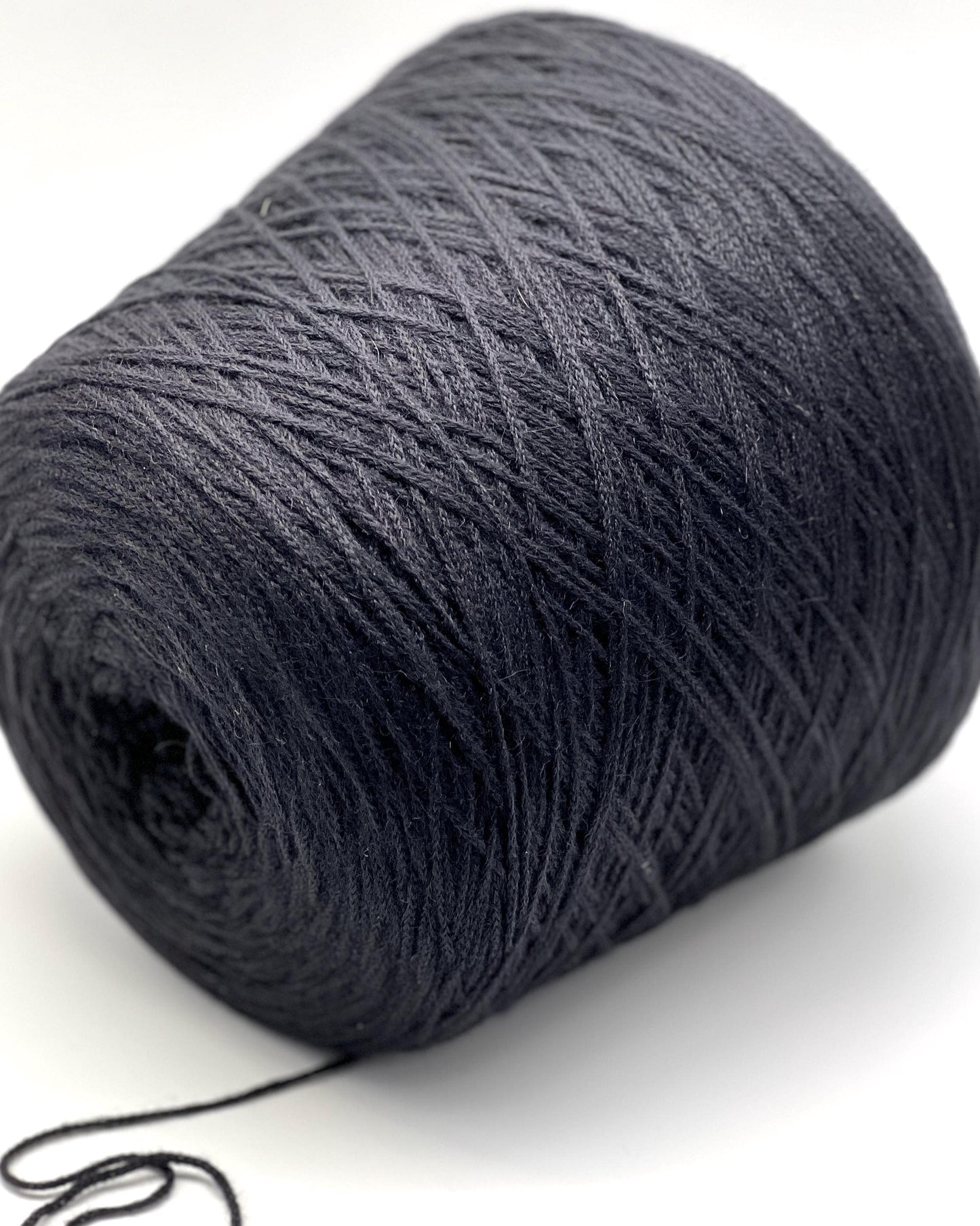 Large ball of dark gray yarn on a white background