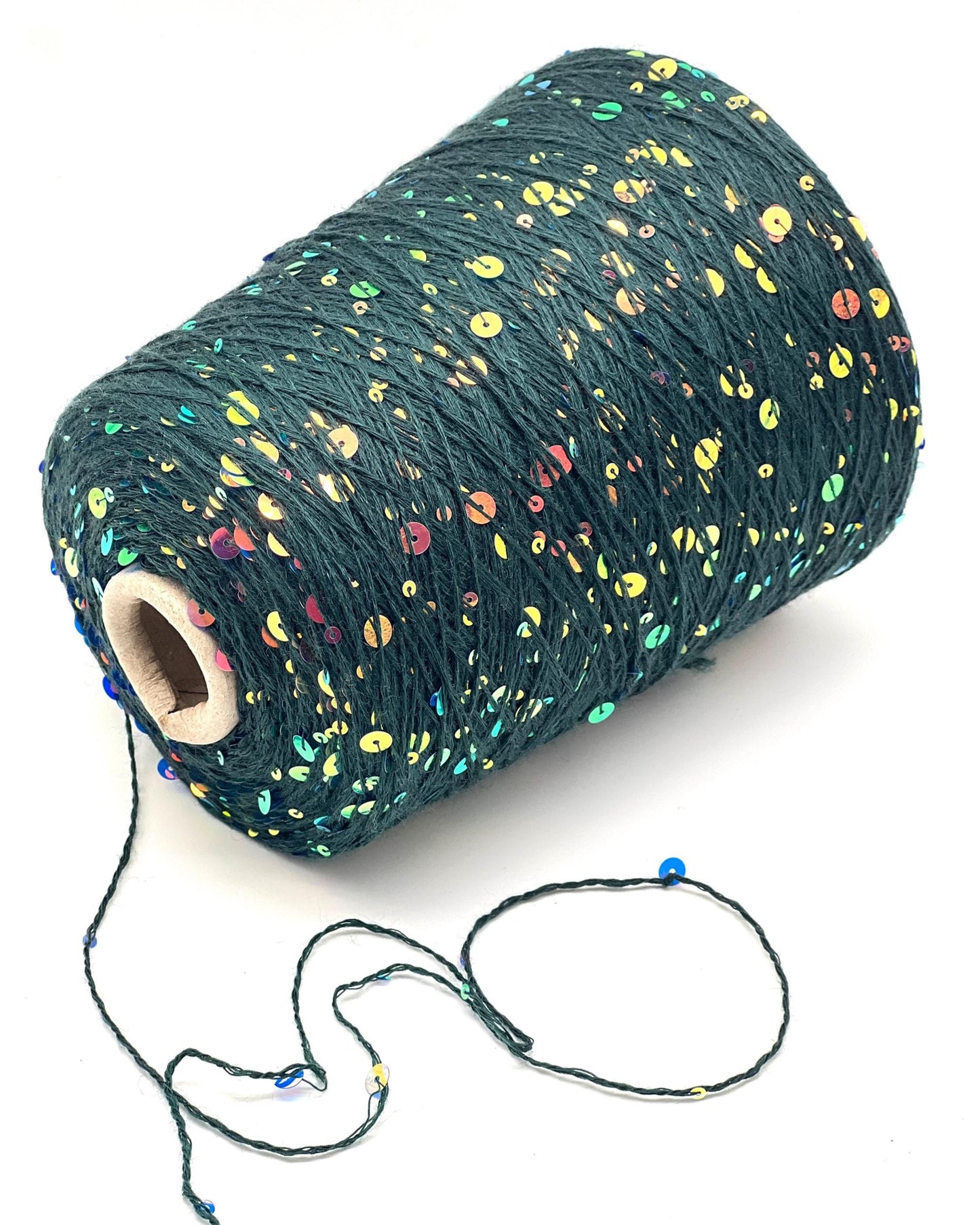 Spool of dark green yarn with multicolored speckles on a white background
