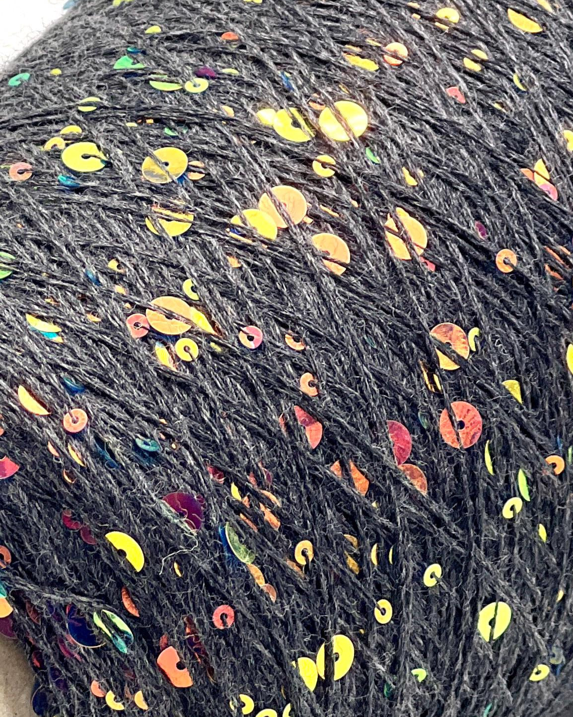 Close-up of dark yarn with colorful speckles