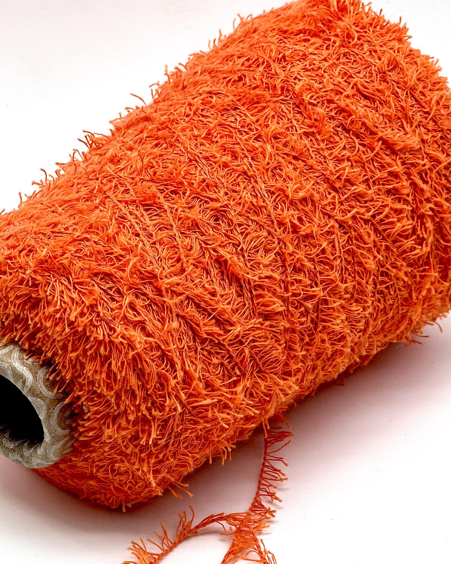 Close-up of an orange scrubber on a white background