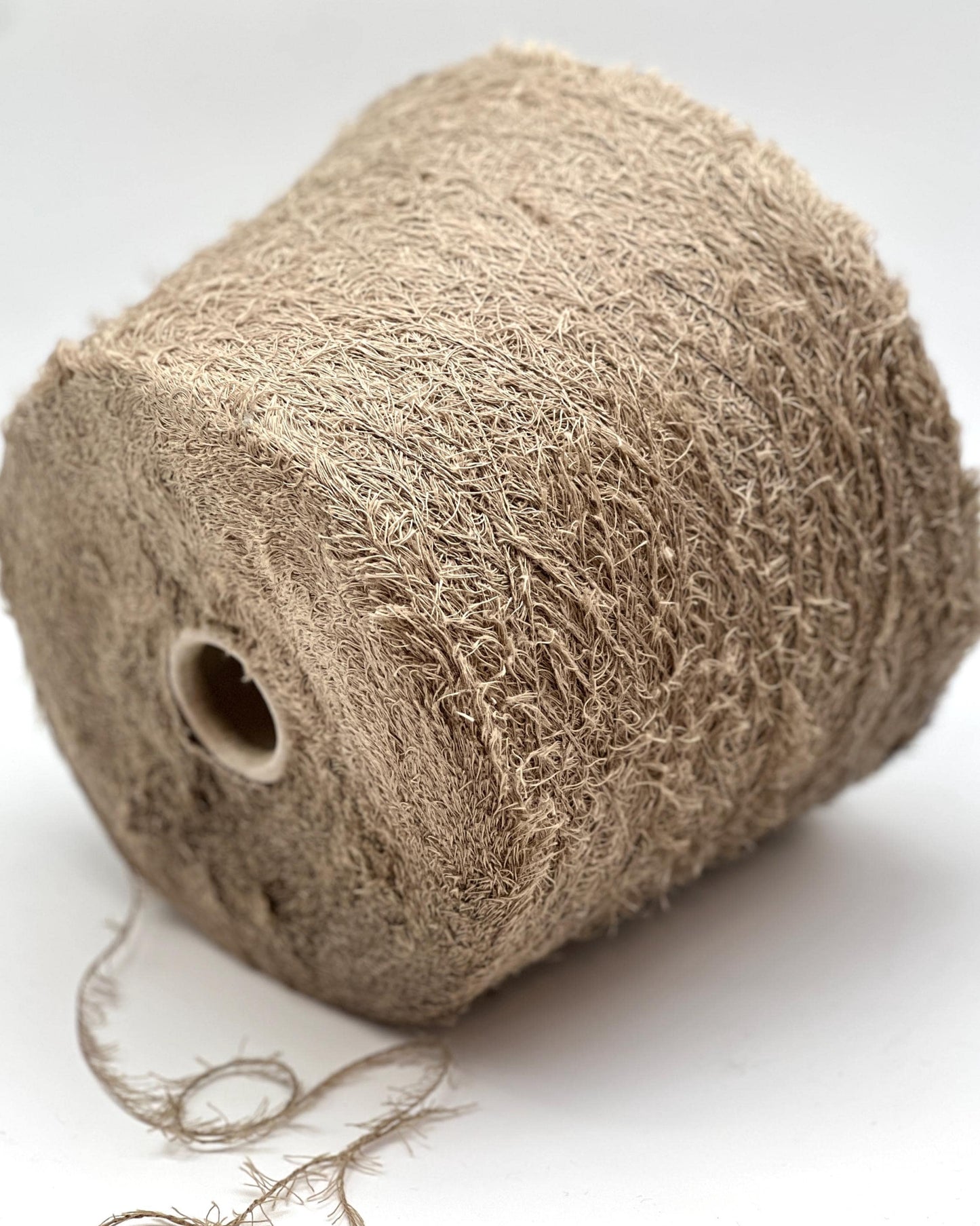 Roll of brown twine on a white background