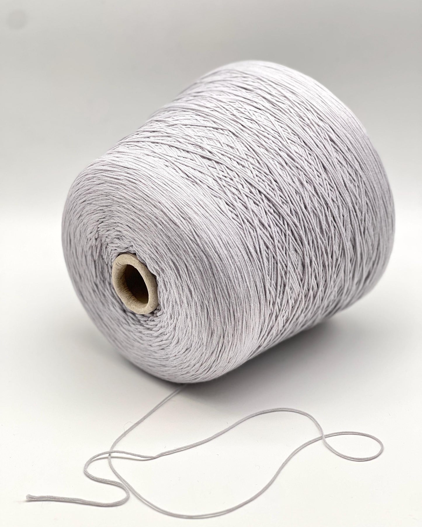 Spool of gray yarn on a white background