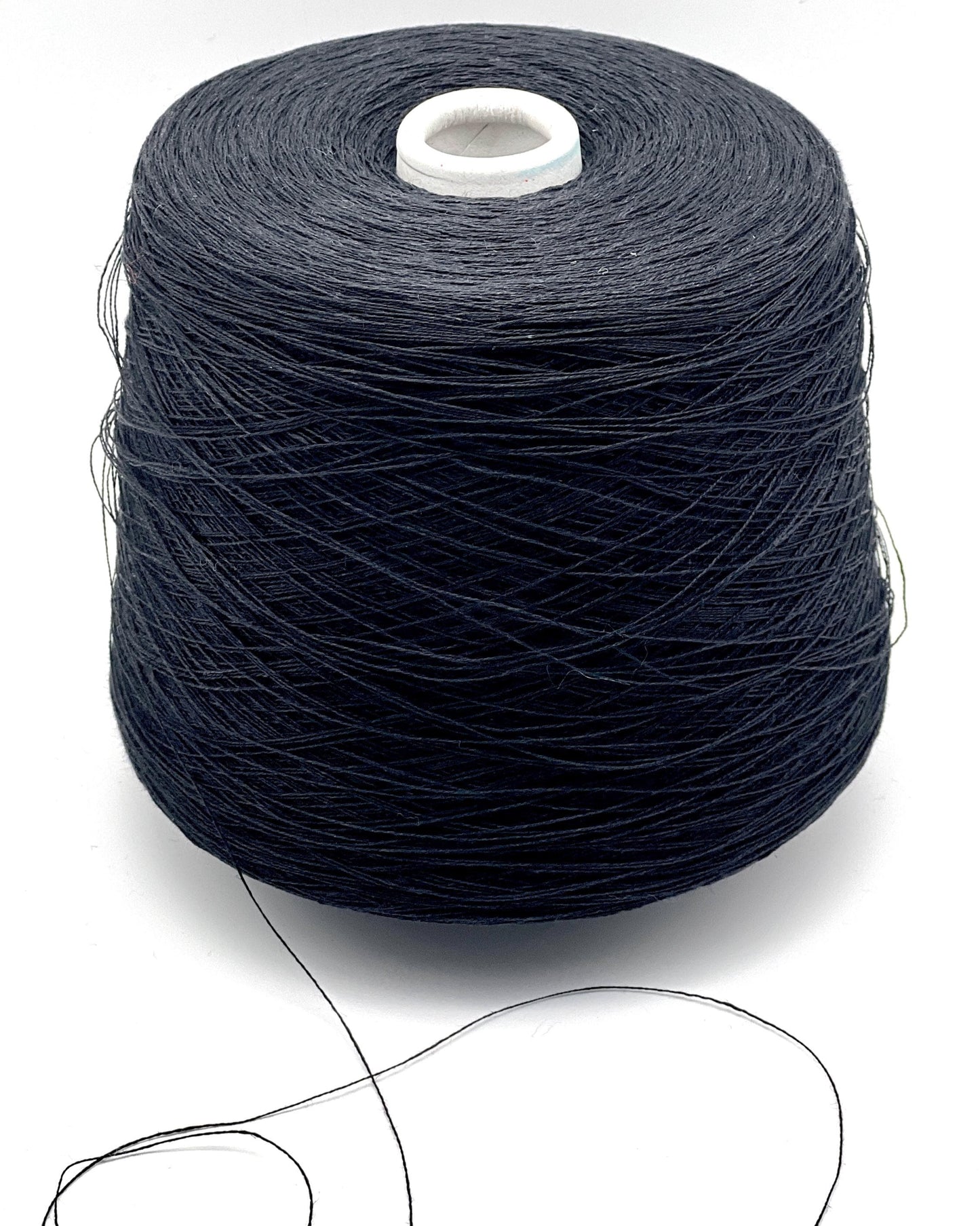 Spool of dark blue thread on a white background