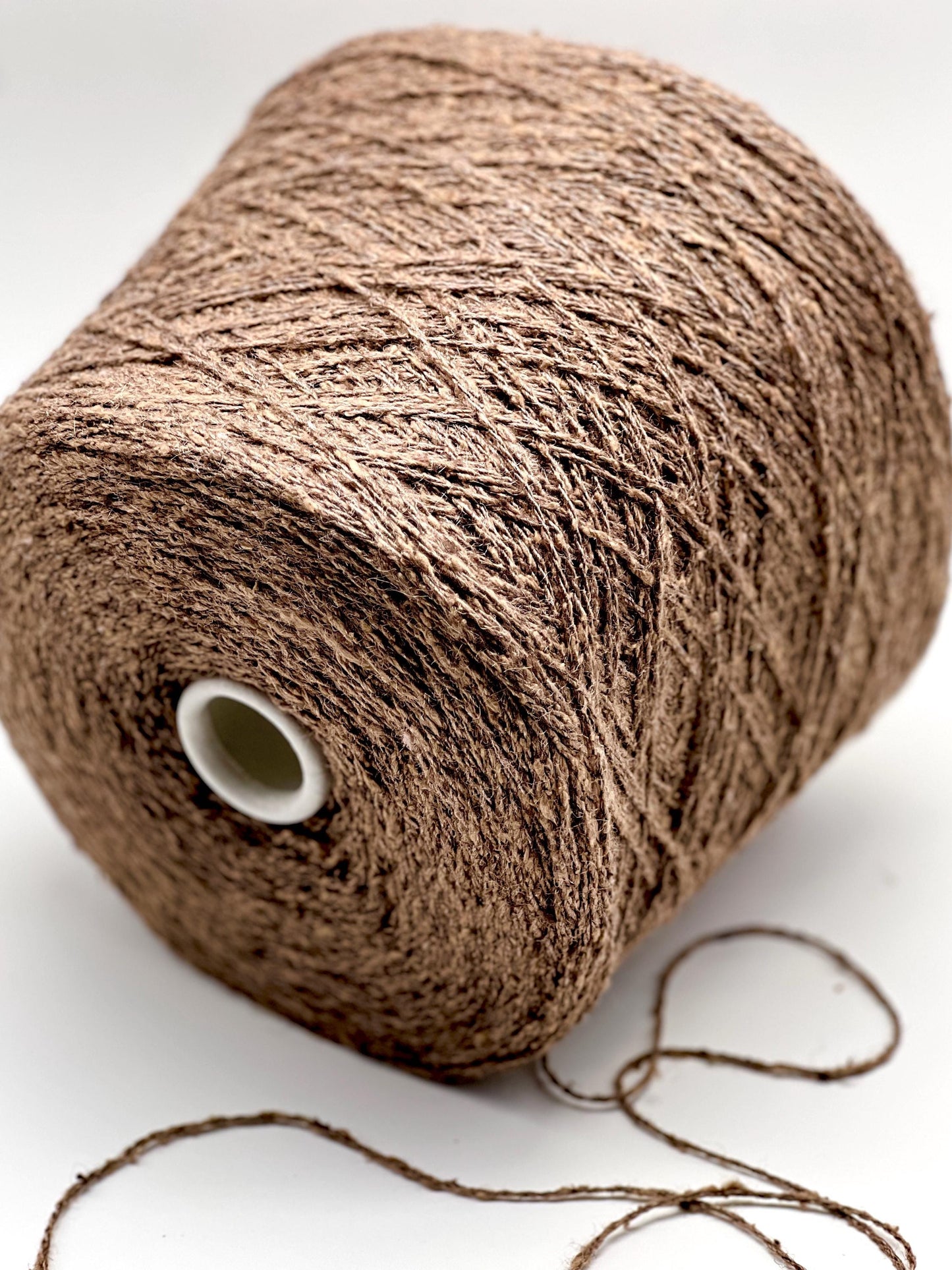 Brown spool of yarn on a white background