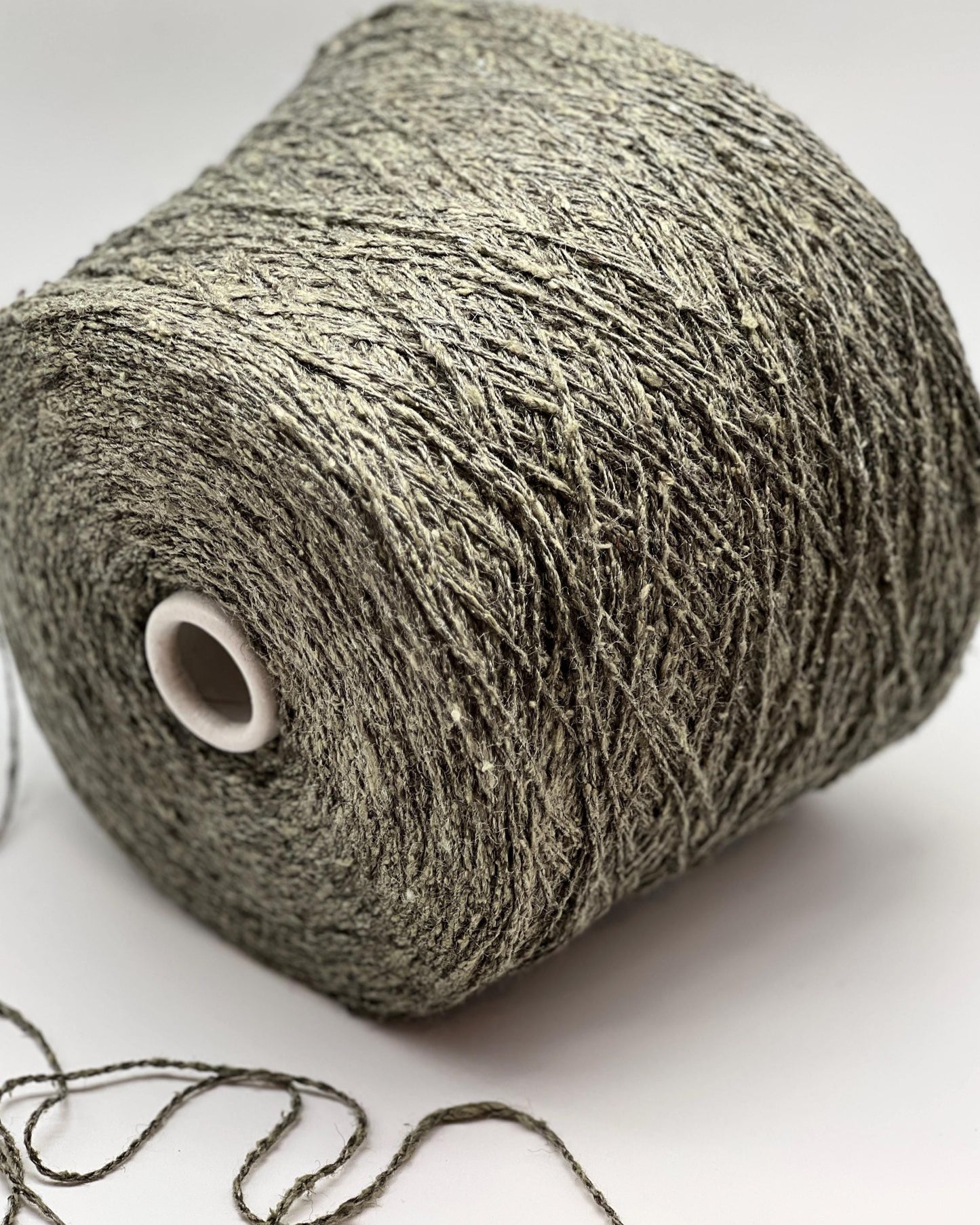 Roll of gray yarn on a white background