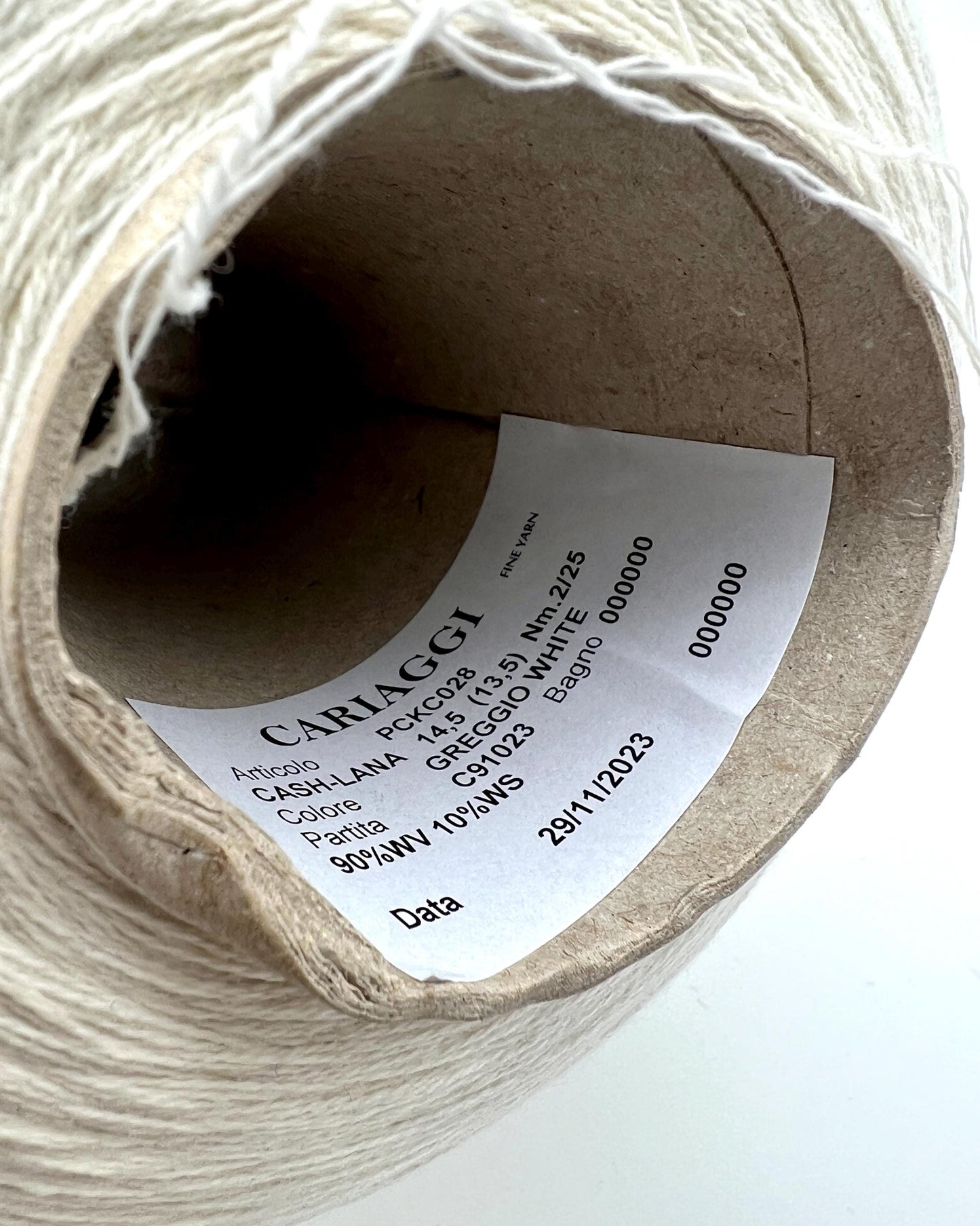 Spool of yarn with a label on a white background
