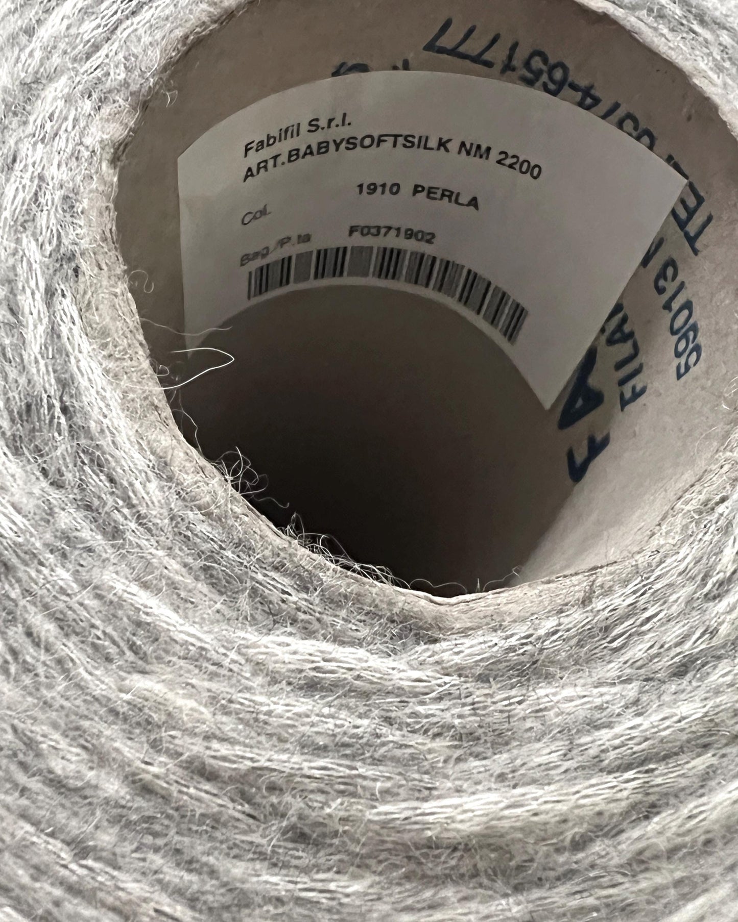 Close-up of a spool of yarn with visible label