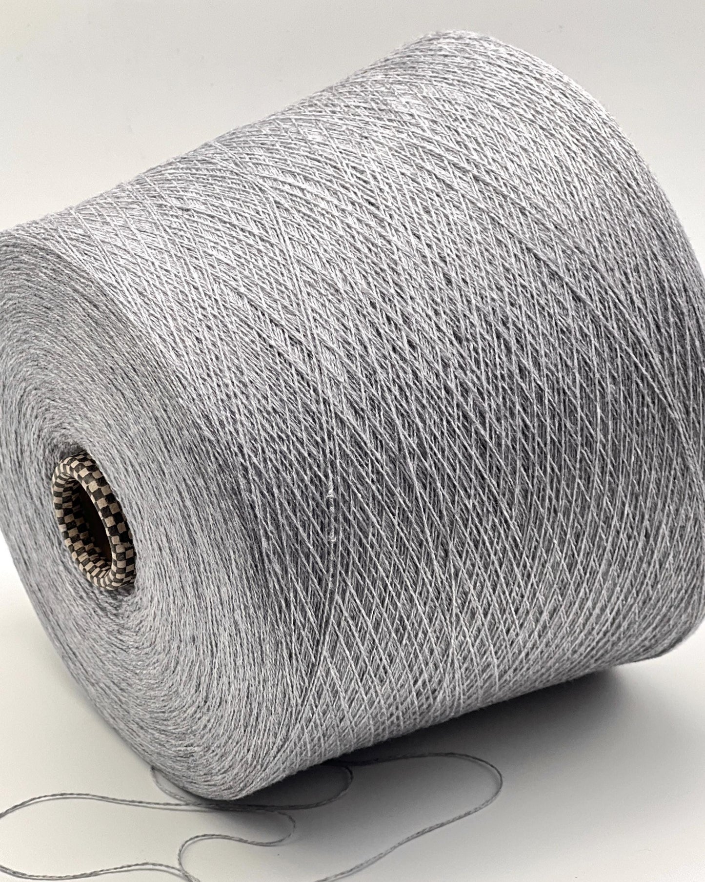 Roll of gray yarn on a white background