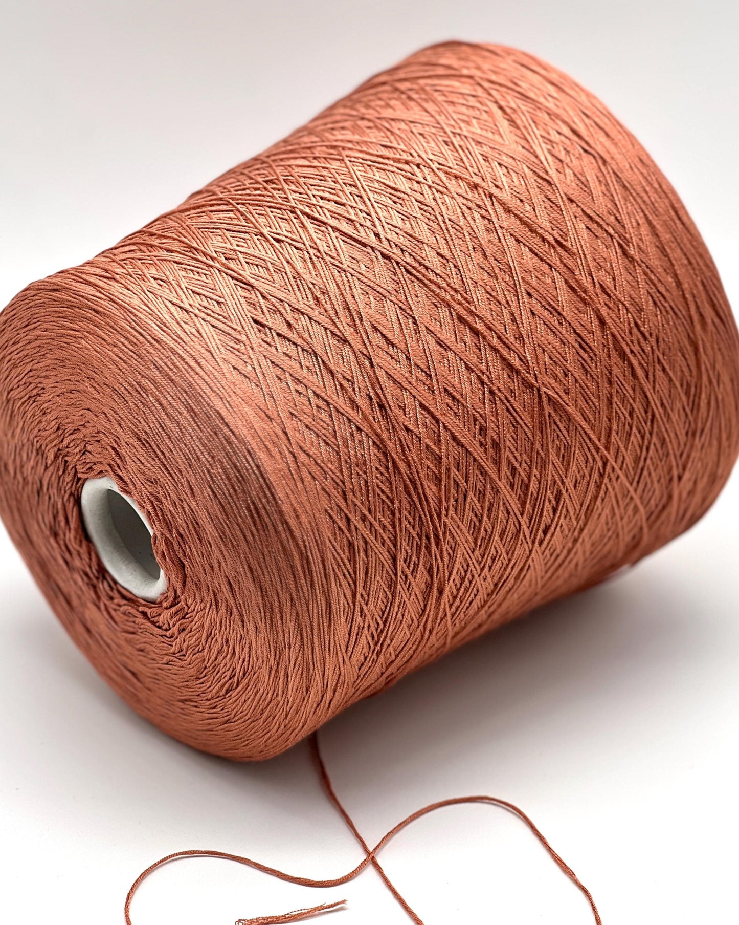 Brown spool of yarn on a white background