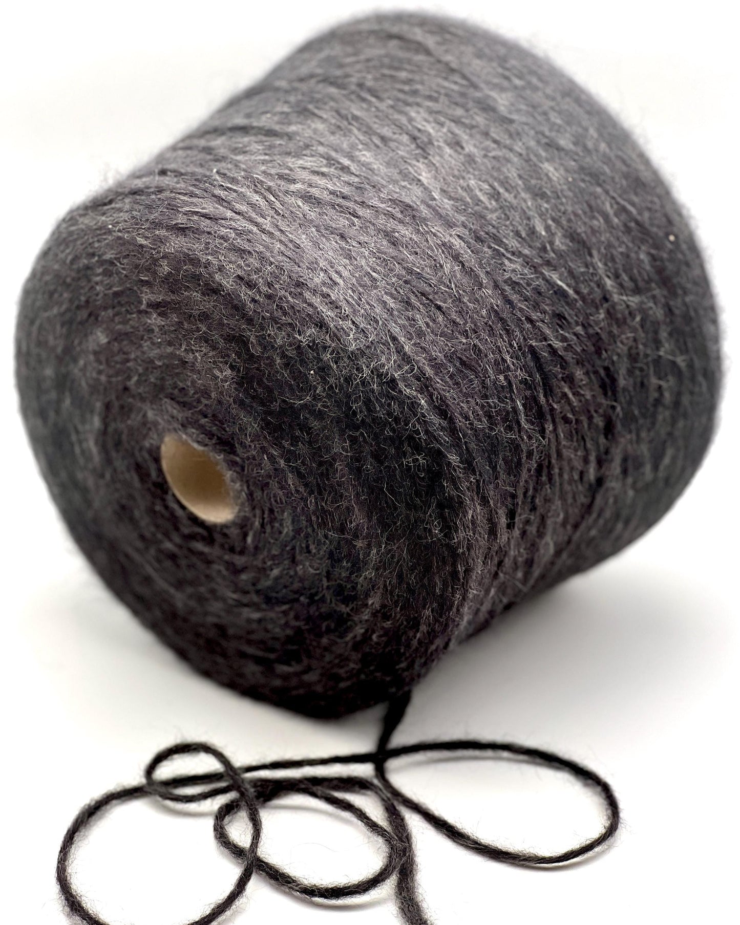 Spool of gray yarn on a white background