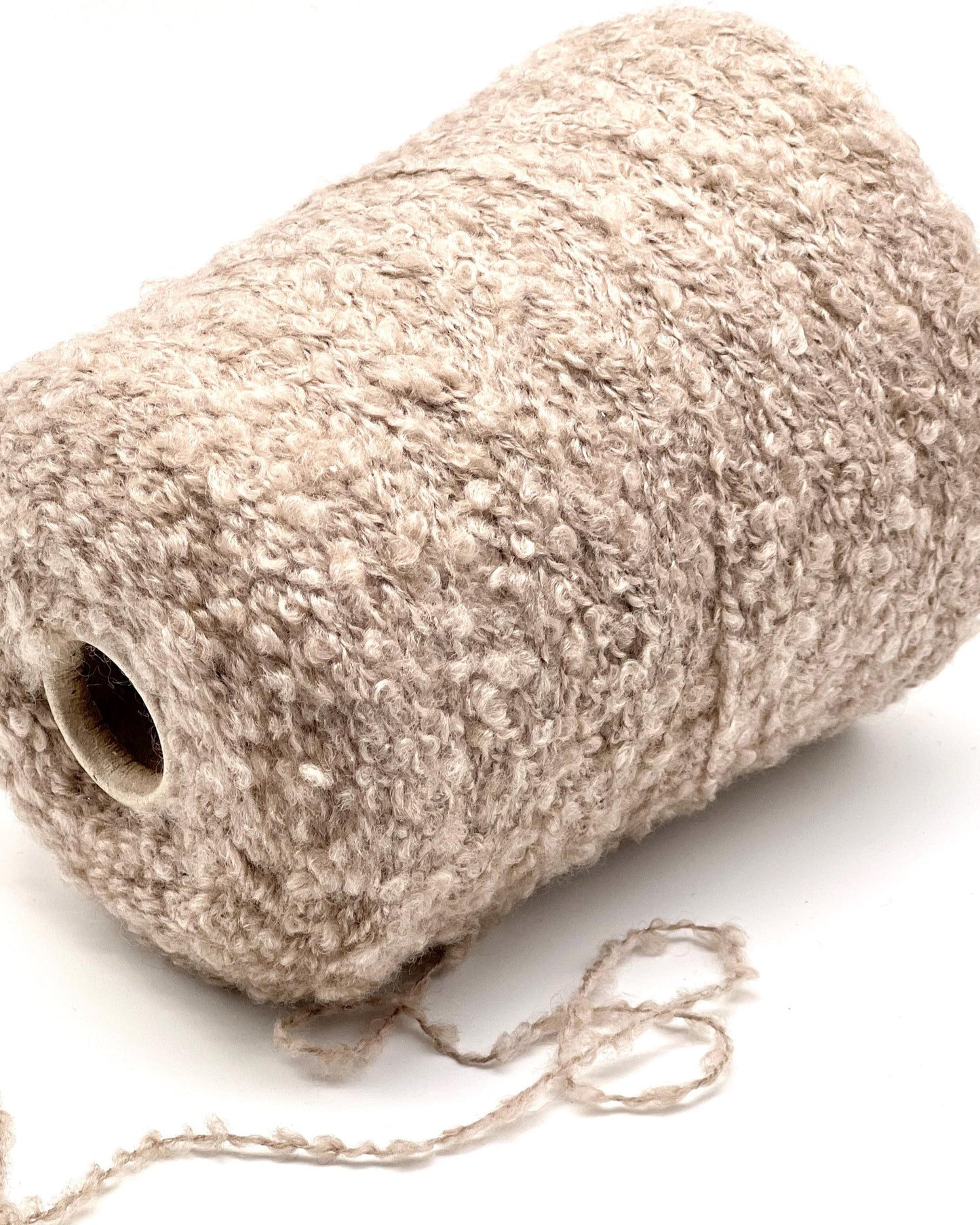 Roll of beige twine on a white background