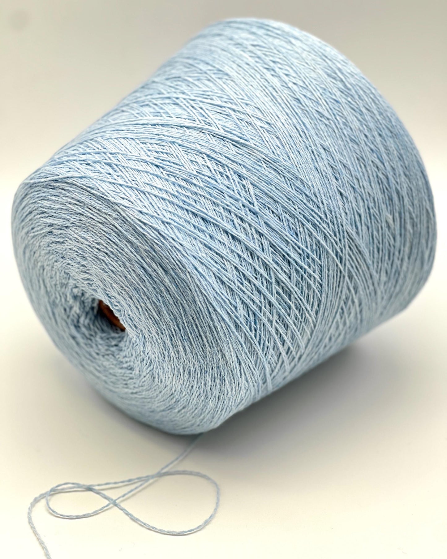 Light blue skein of yarn on a white background