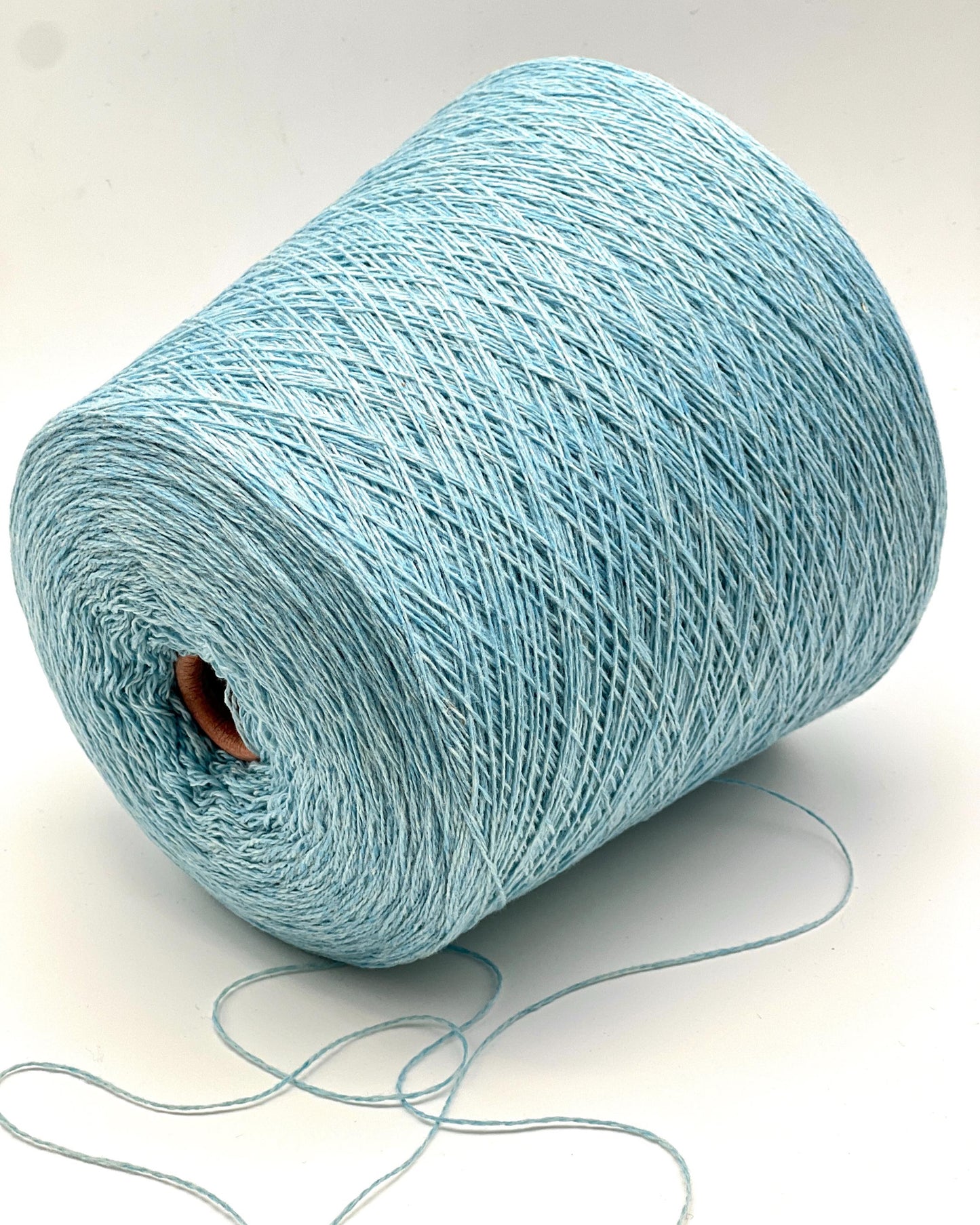 Light blue yarn spool on a white background