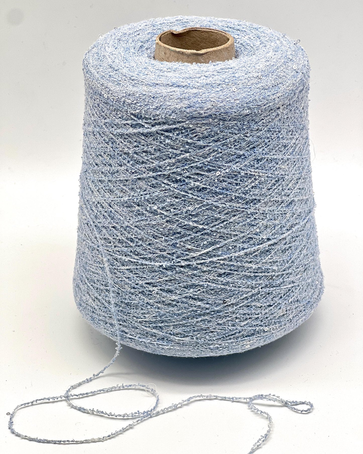 Spool of blue yarn on a white background