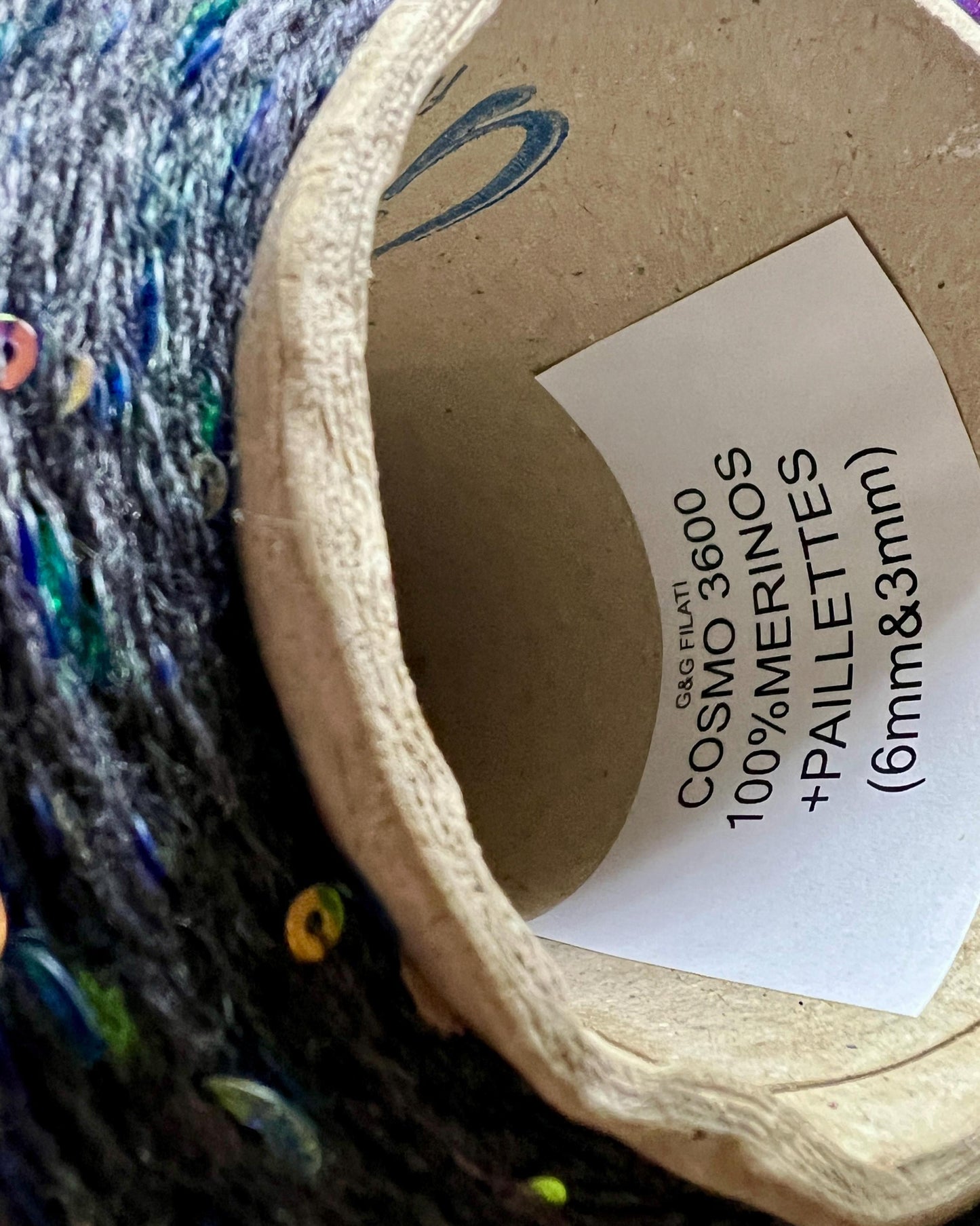 Yarn ball with a label on a textured background