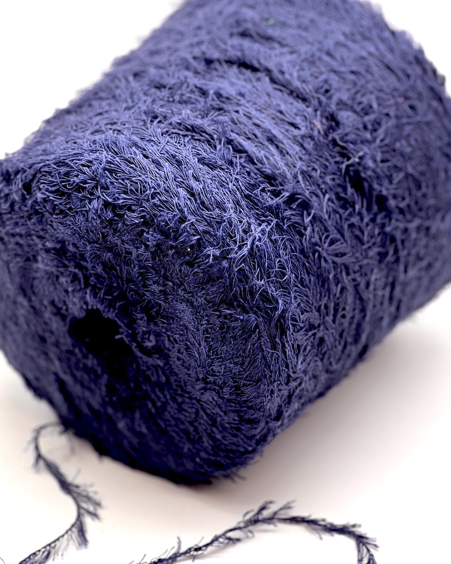 Close-up of a blue textured sponge on a white background