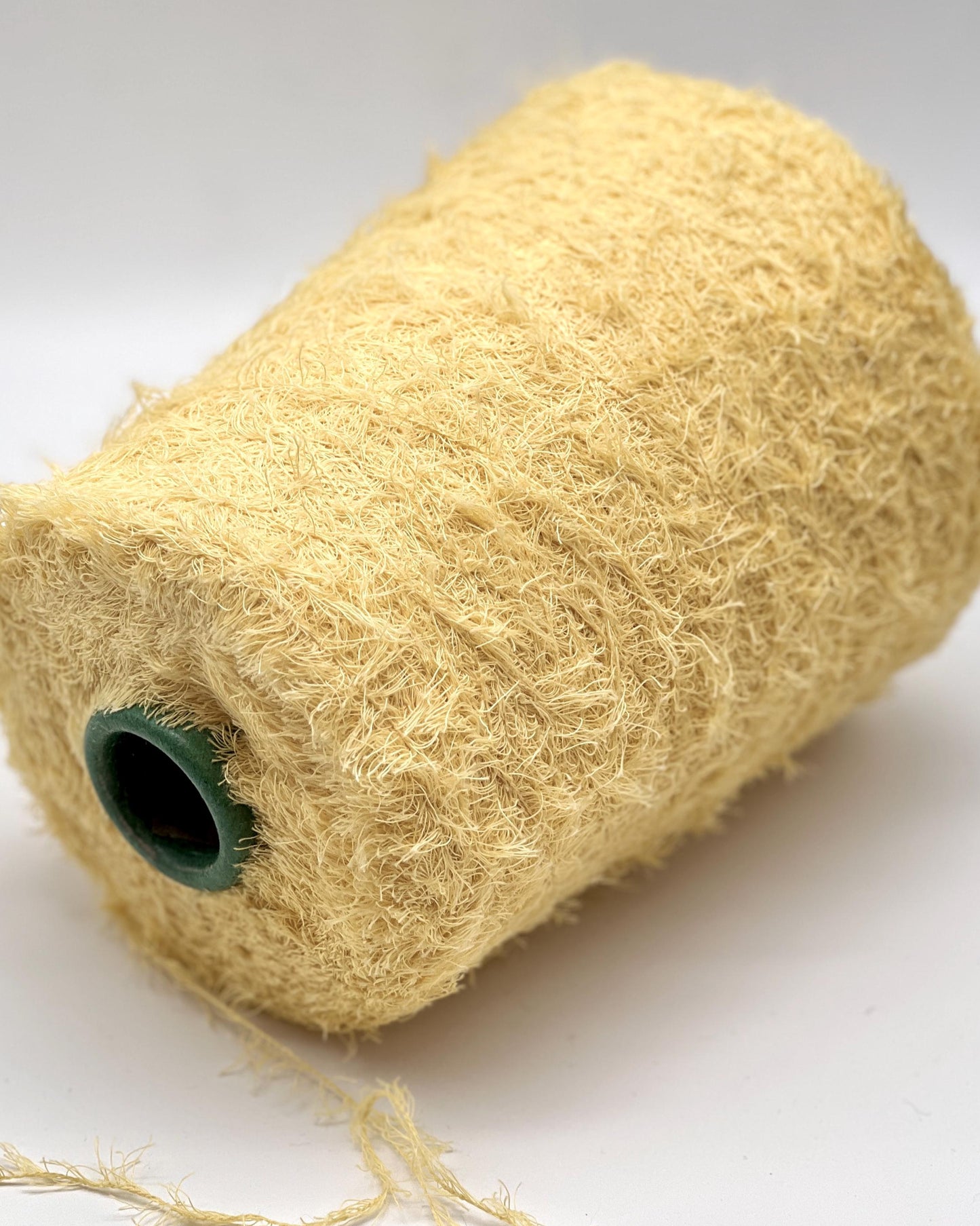 Roll of beige twine on a white background