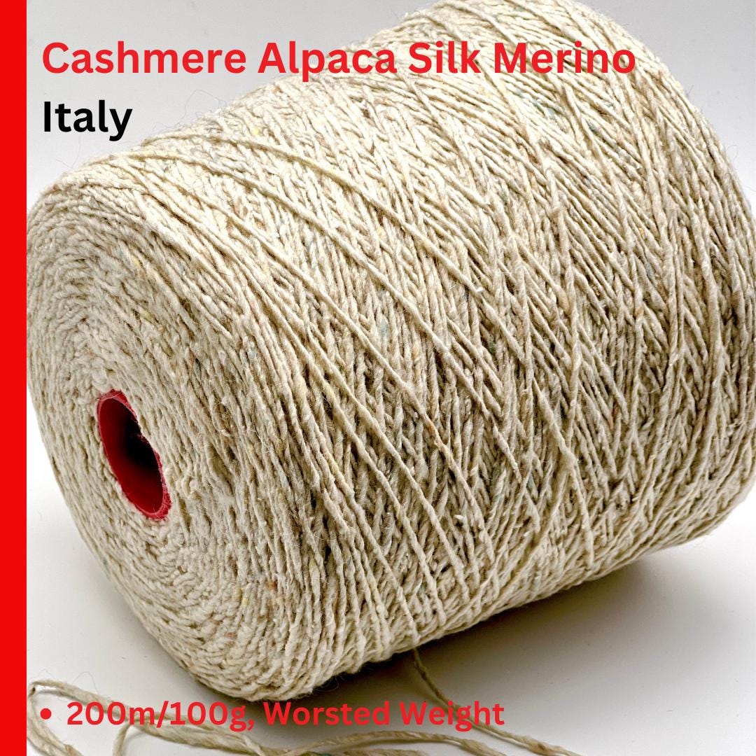 Rolled-up skein of yarn with text indicating material composition and origin