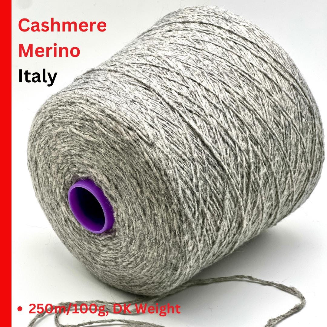 Spool of cashmere merino yarn with 'Cashmere Merino Italy' text on a white background