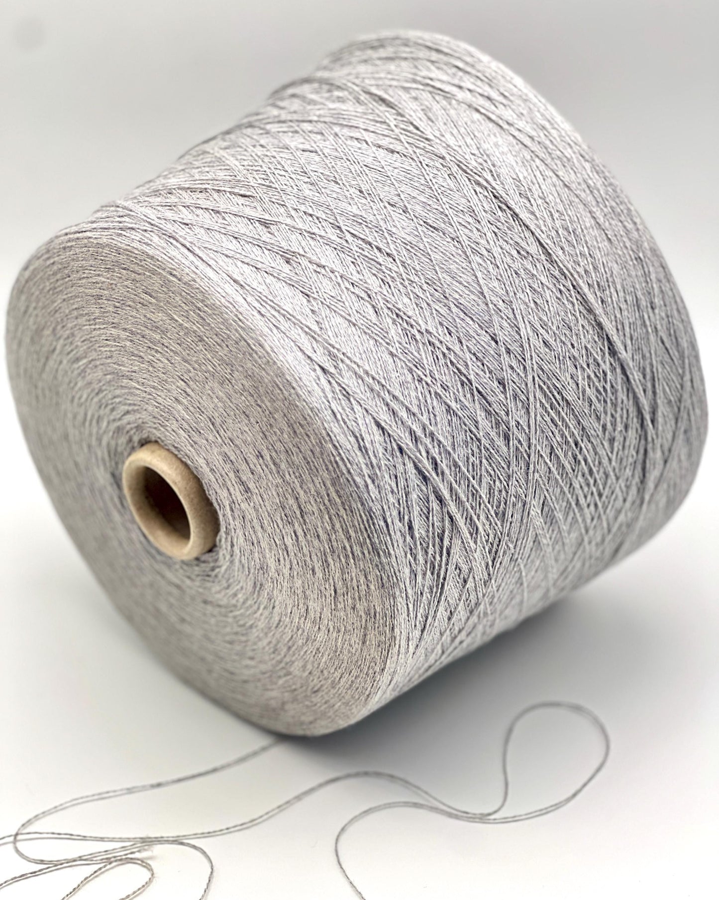 Spool of gray yarn on a white background