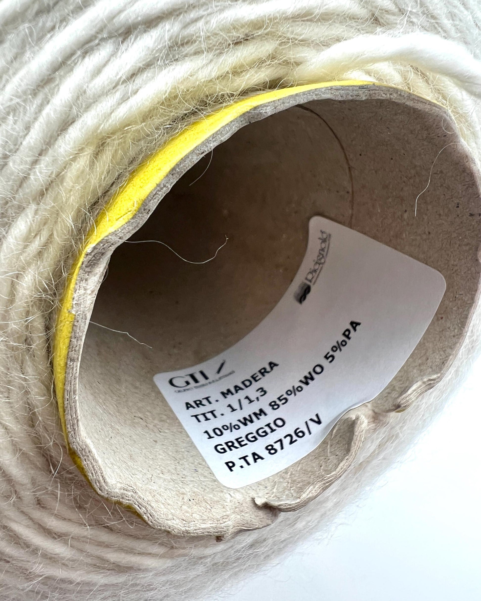 Spool of yarn with a label on a white background