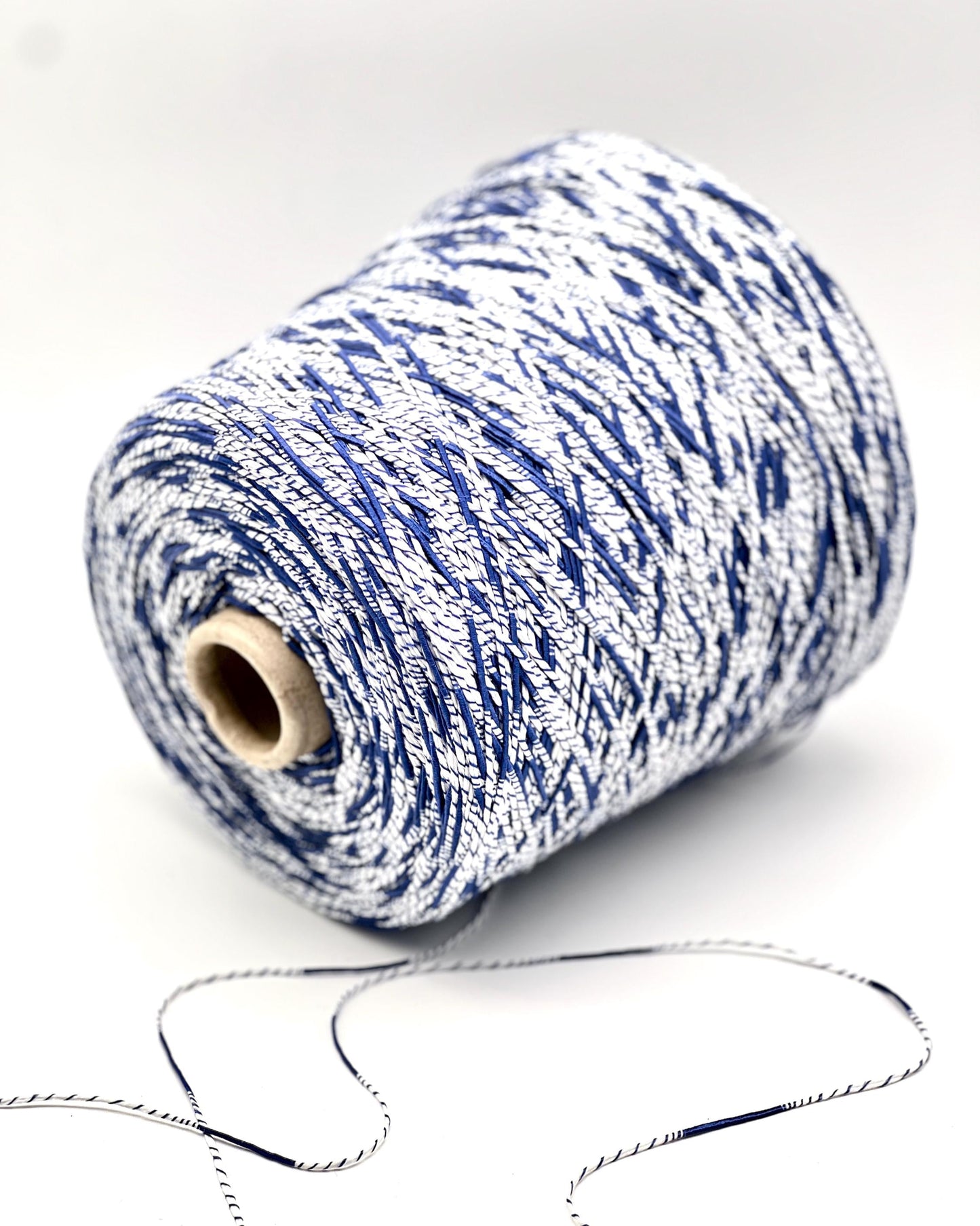 Spool of blue and white yarn on a white background