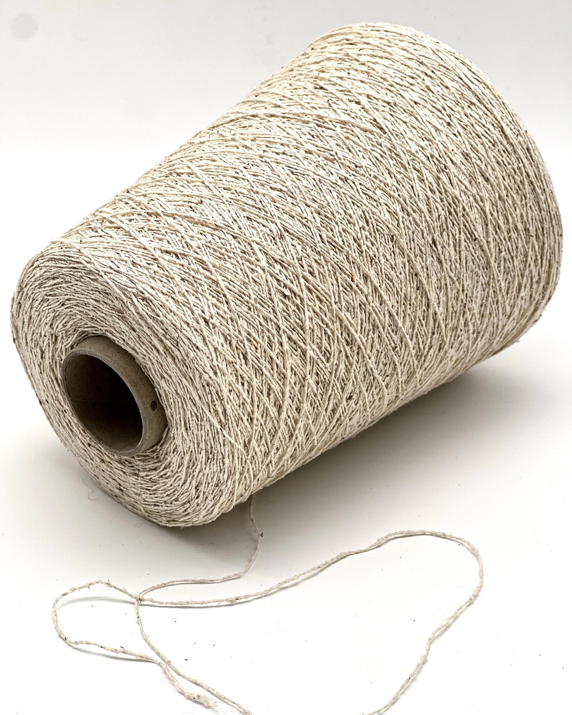 Spool of beige thread on a white background