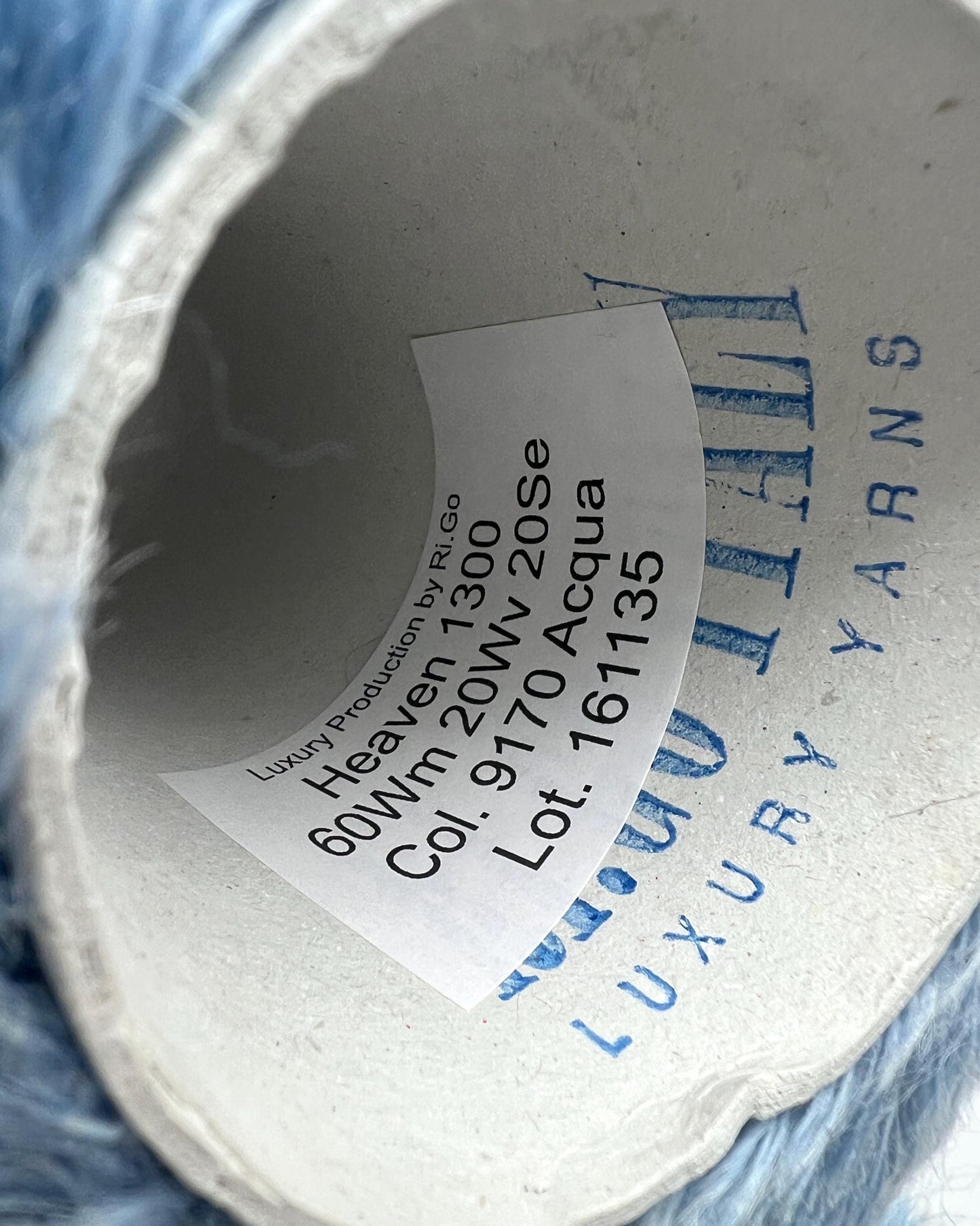 Close-up of a spool of yarn with a label showing product details.