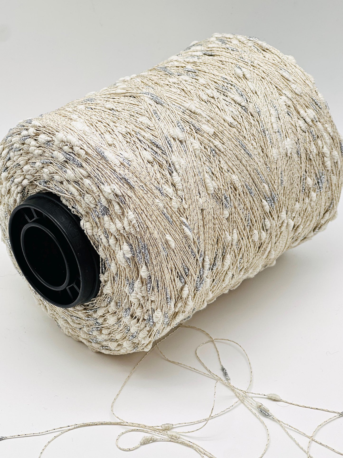 Spool of beige string on a white background