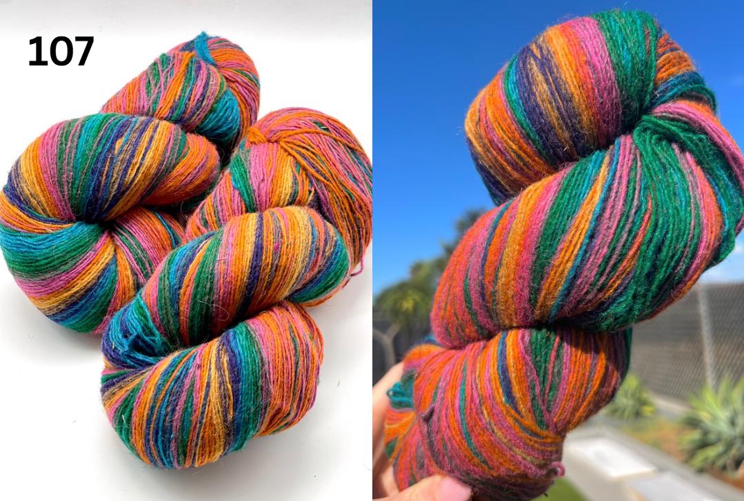 Multicolored skein of yarn on a white background with a blurred outdoor background.