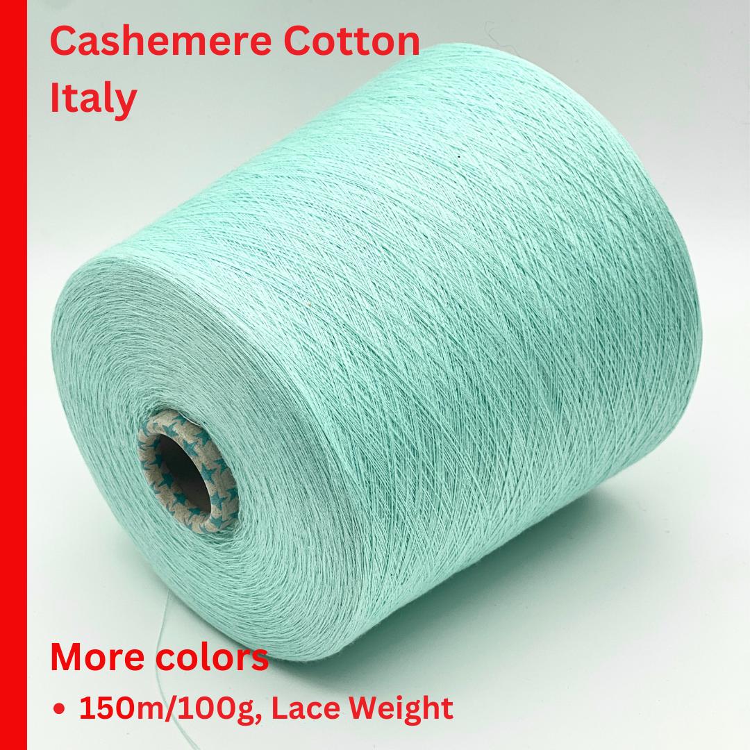 Roll of light blue yarn with text about cashmere cotton from Italy on a white background.