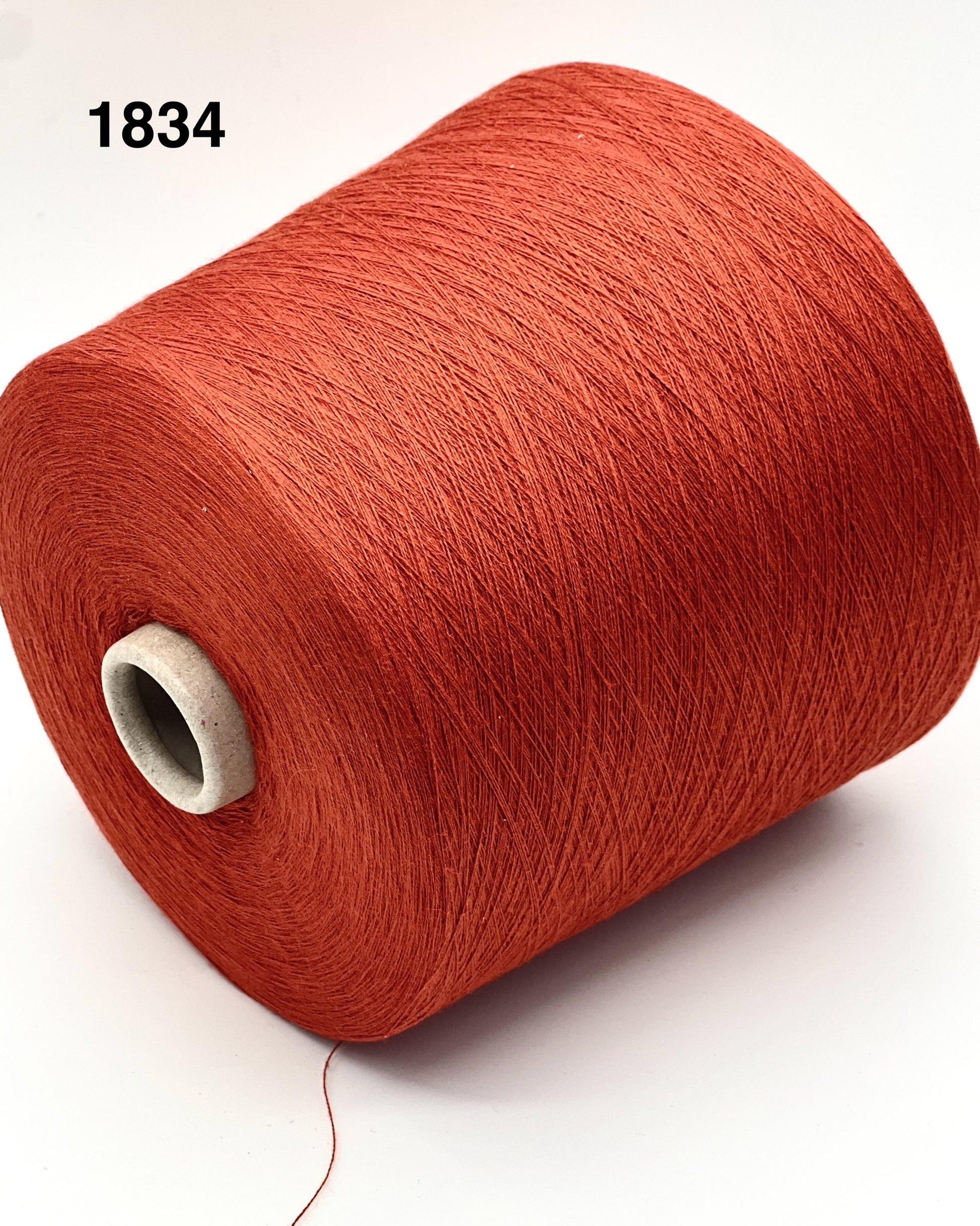 Red yarn spool on a white background