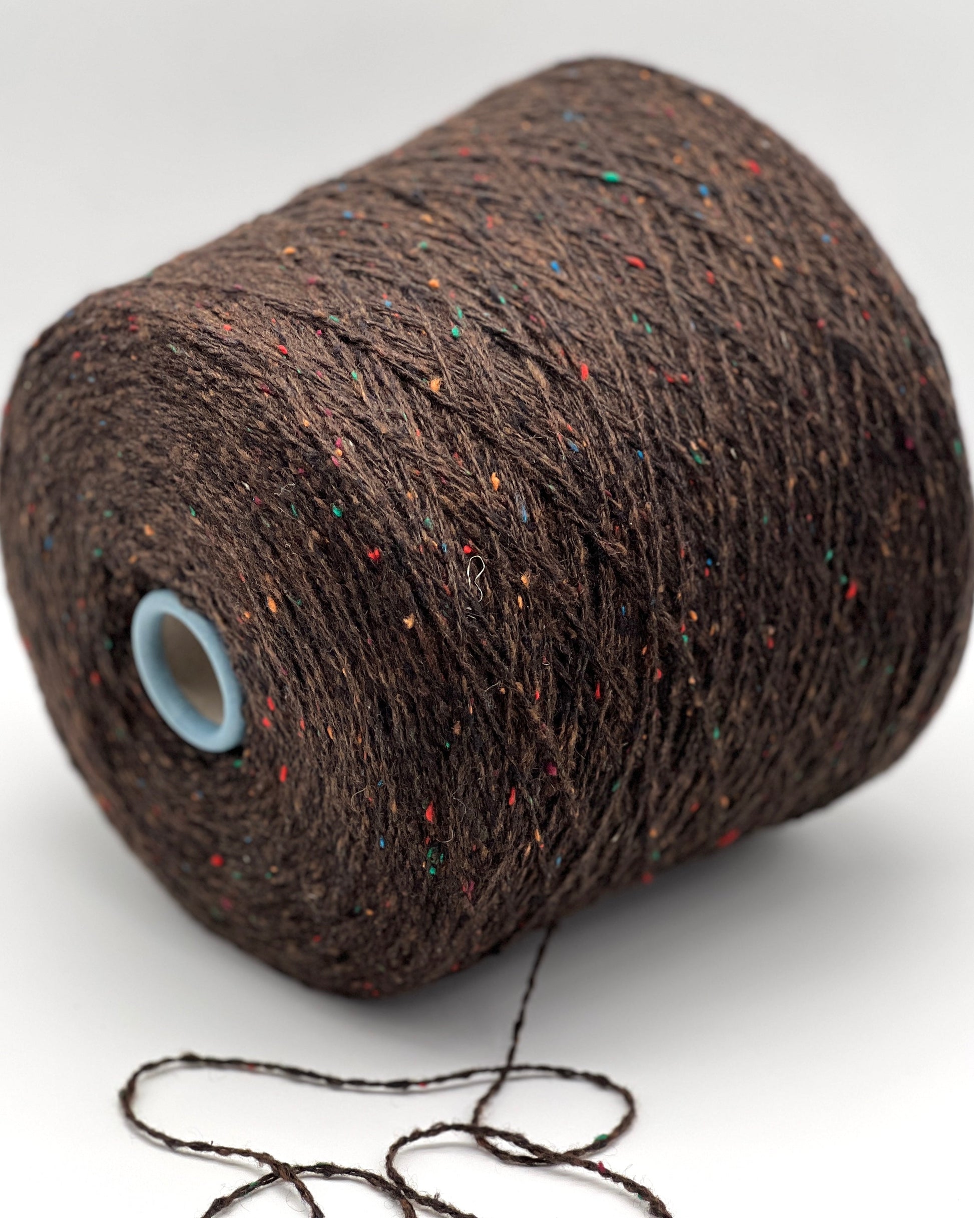 Gruppo Tessile Industriale WEB TWEED Italian cashmere yarn shown on professional cones. This 100% carded cashmere sport weight yarn features a subtle, modern tweed texture and soft loft. Premium luxury designer yarn available at iDOKNiT.com.