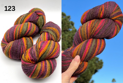 Small-batch dyed skeins of 100% Latvian Dark-Headed Sheep Wool in varied earth tones and vibrant multi-colors like Green-Brown striped 052. The rustic single-ply texture is shown in detail, including images of the sheep and the historic Paces Vilnas Fabrika origin. Available at iDOKNiT.com.