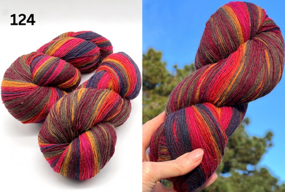 Small-batch dyed skeins of 100% Latvian Dark-Headed Sheep Wool in varied earth tones and vibrant multi-colors like Green-Brown striped 052. The rustic single-ply texture is shown in detail, including images of the sheep and the historic Paces Vilnas Fabrika origin. Available at iDOKNiT.com.