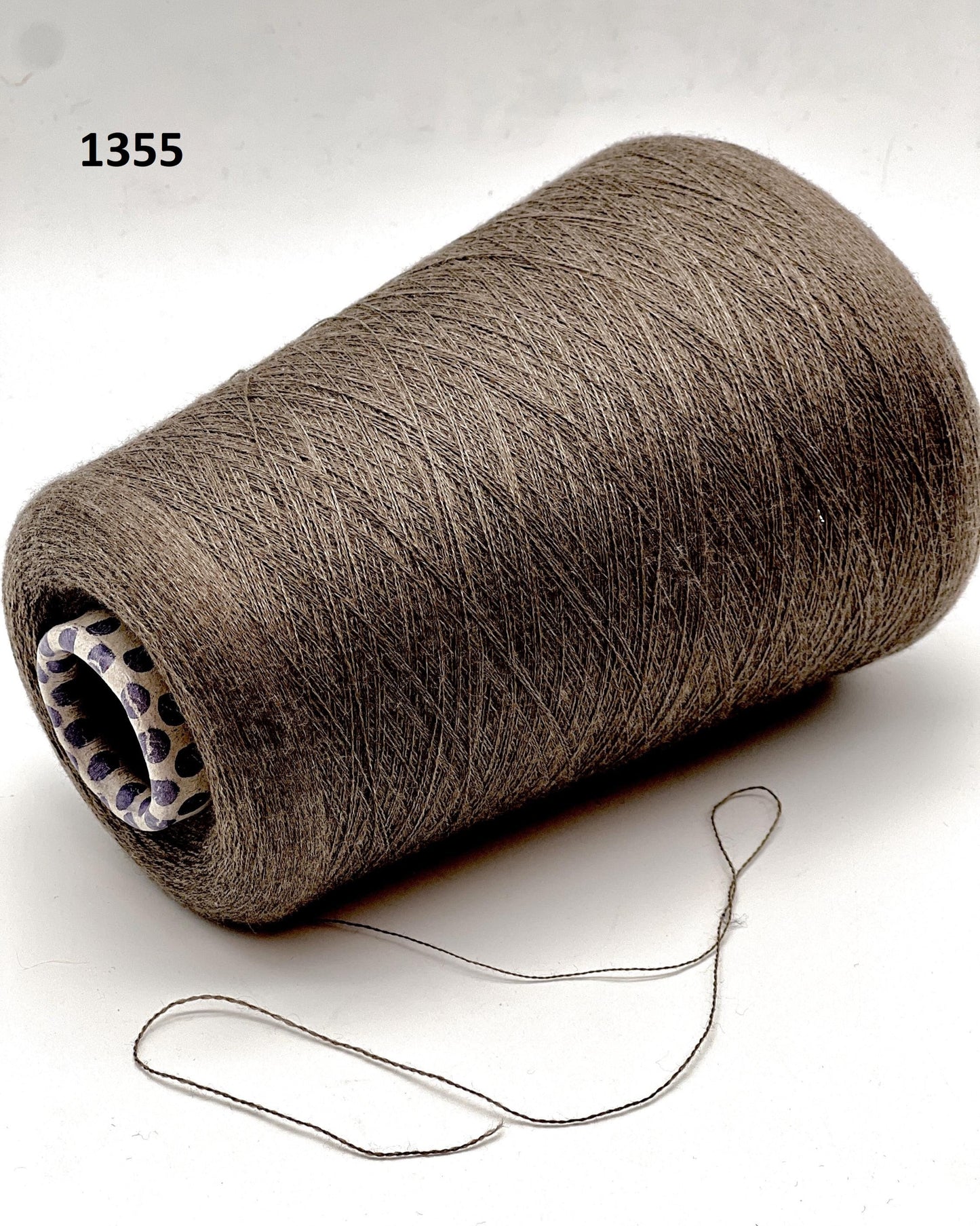 Spool of brown thread on a white background