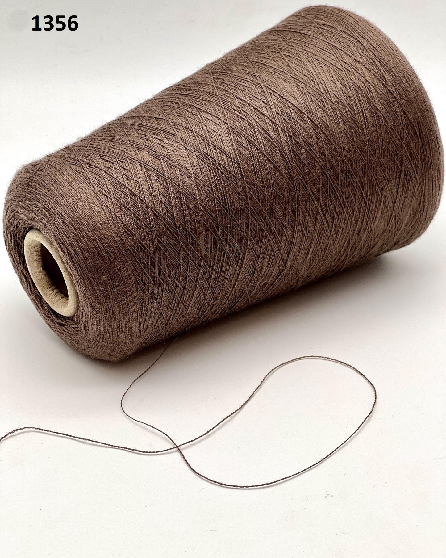 Brown spool of thread on a white background